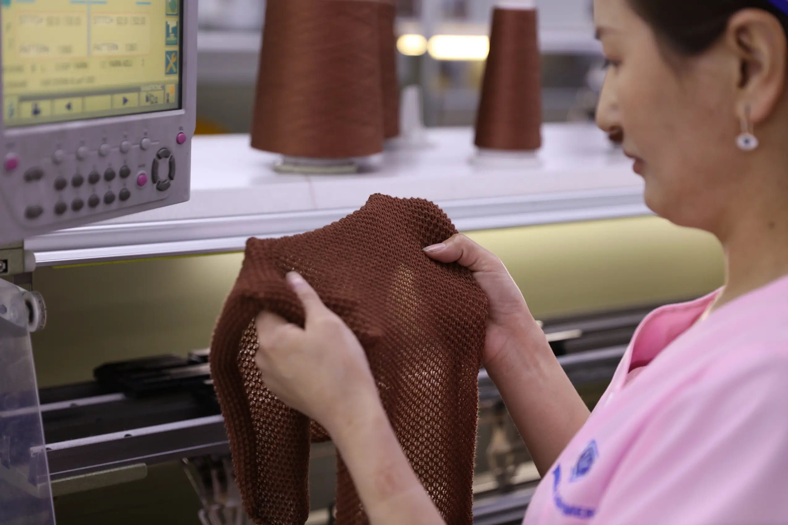 factory worker testing cashmere sweater
