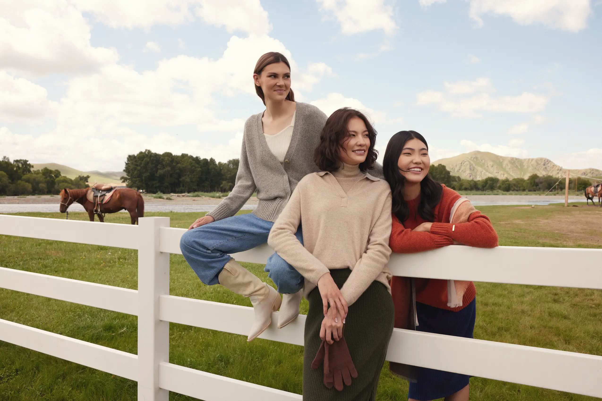 group of cashmere models on a fence