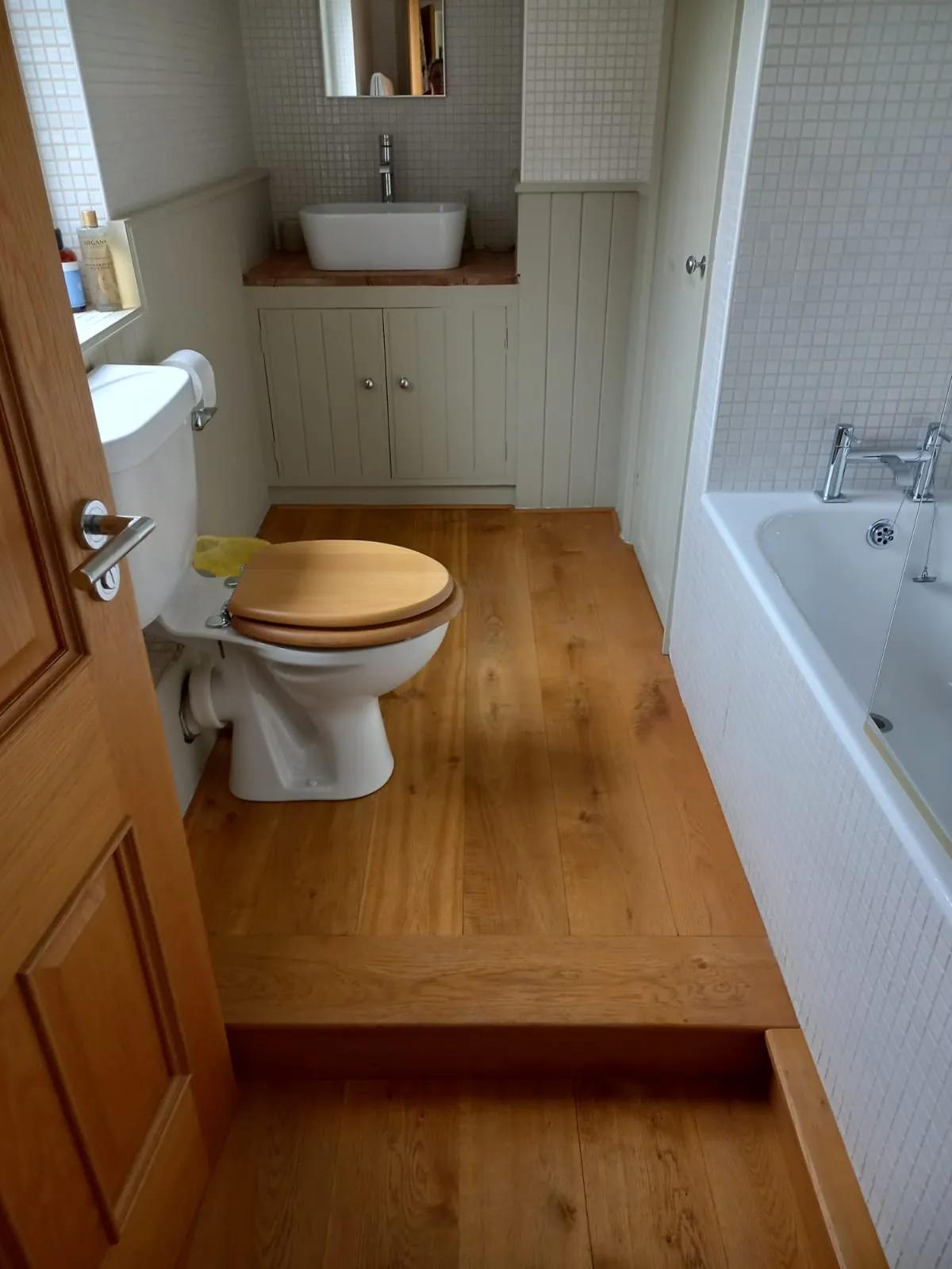 Bathroom with wooden floor freshly cleaned