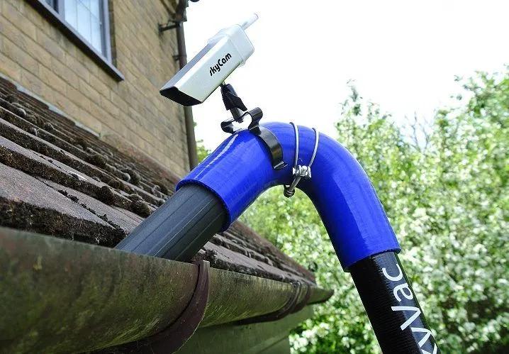 Pipe with camera attached going down a gutter on a local Jersey house