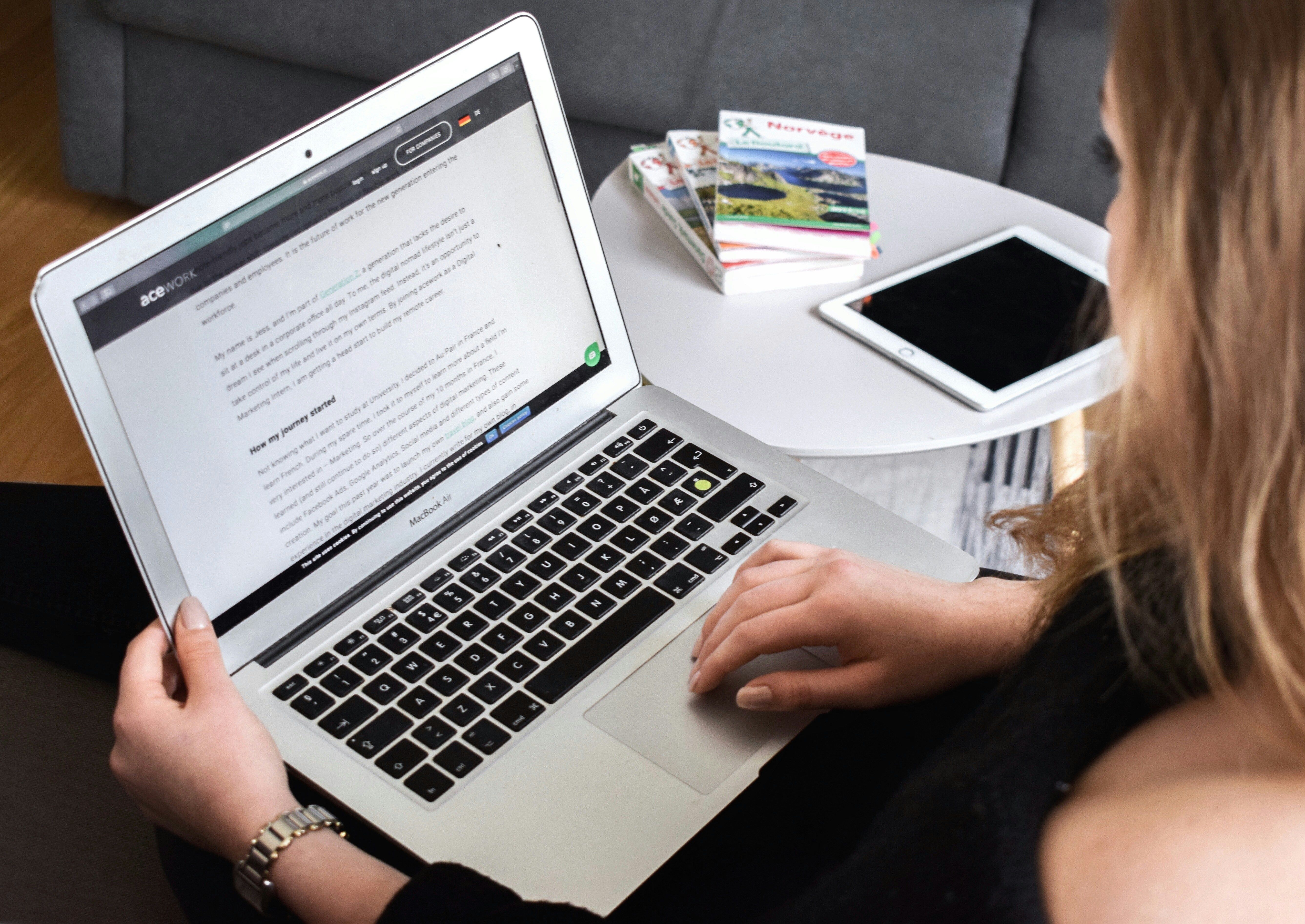 A woman reading content on a laptop