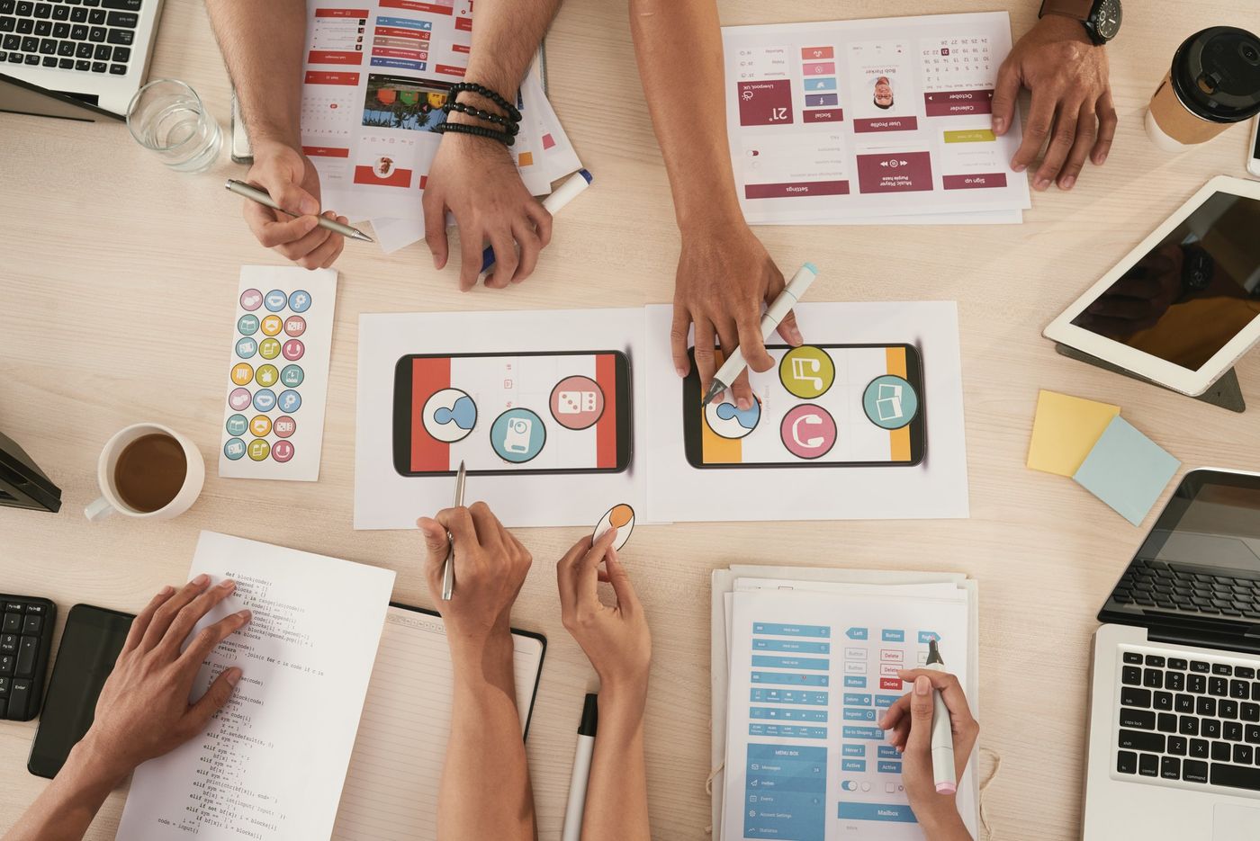 User testing vs. usability testing: a team of developers discuss changes to an app