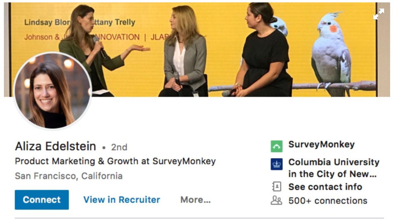 An example of a woman's LinkedIn profile with a cover photo showing her talking with other women
