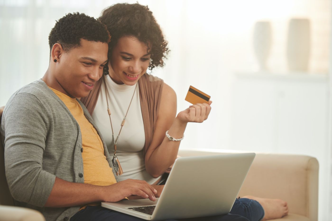 How to launch a successful crowdfunding campaign: a couple shops online, ready to make a purchase.