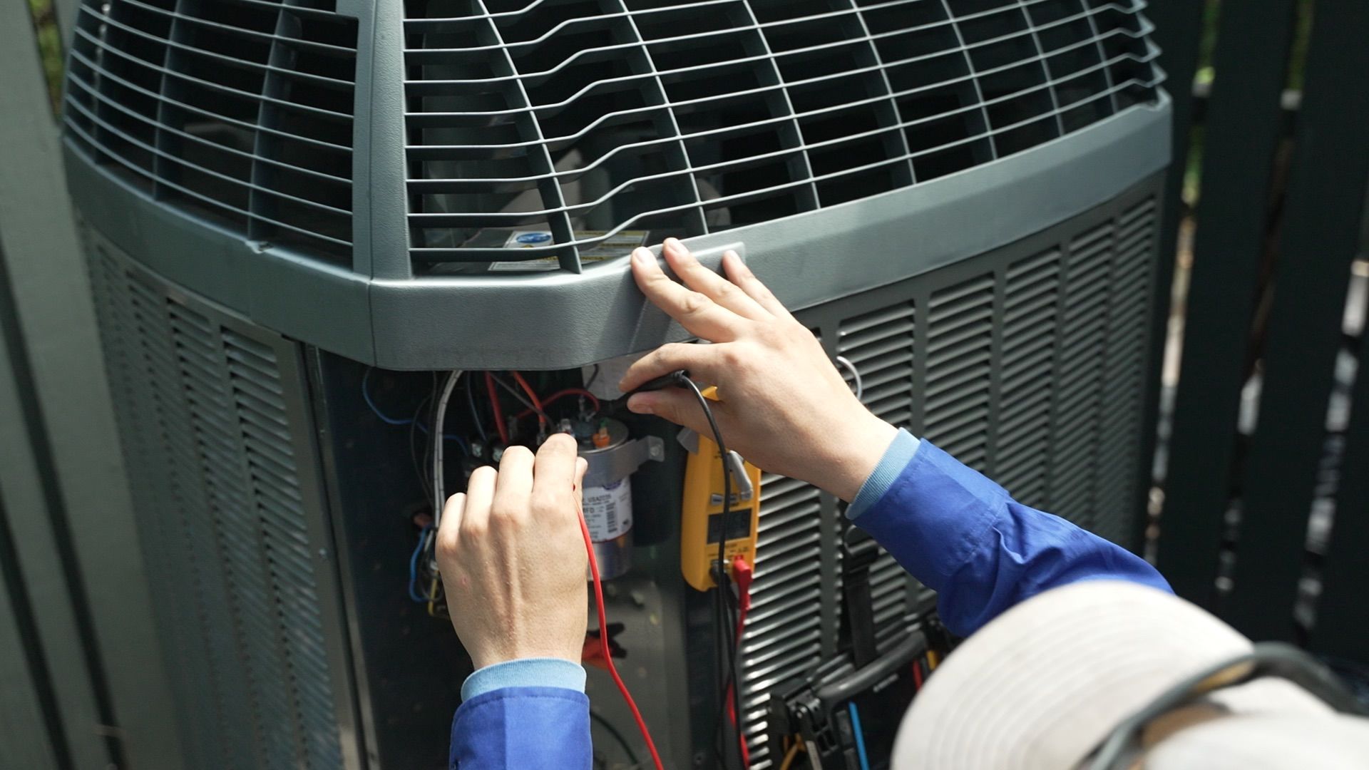 Licensed HVAC contractor inspecting air conditioning unit during preventive maintenance visit in Bulverde