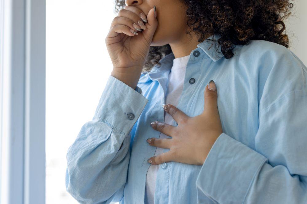 A person coughing into their hand