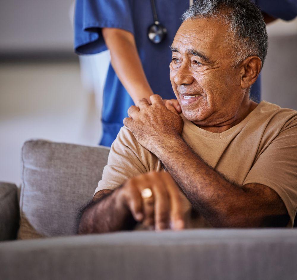 A clinician with a patient in a hospital consulting room