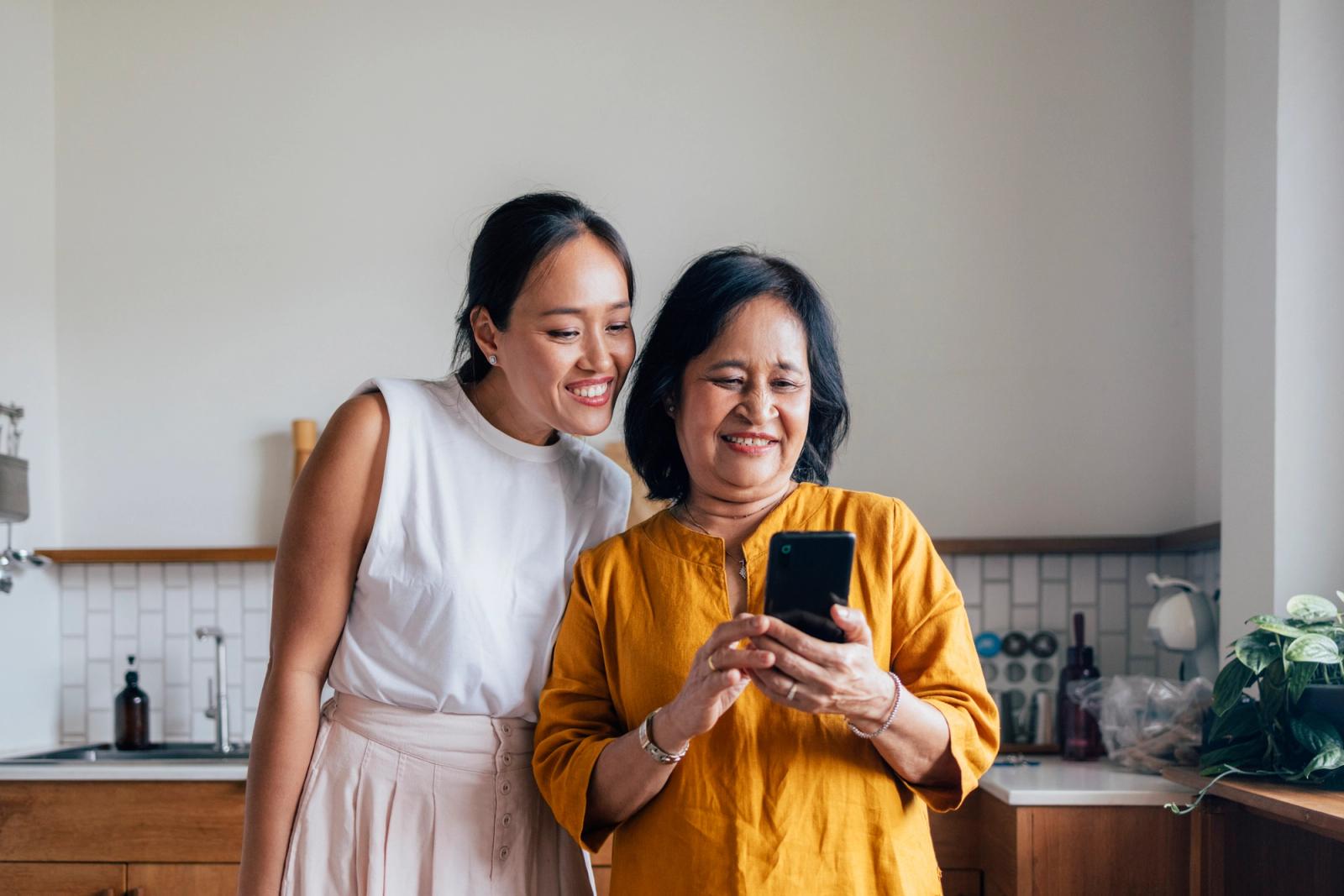 A woman taking a Helfie vitals check with her phone