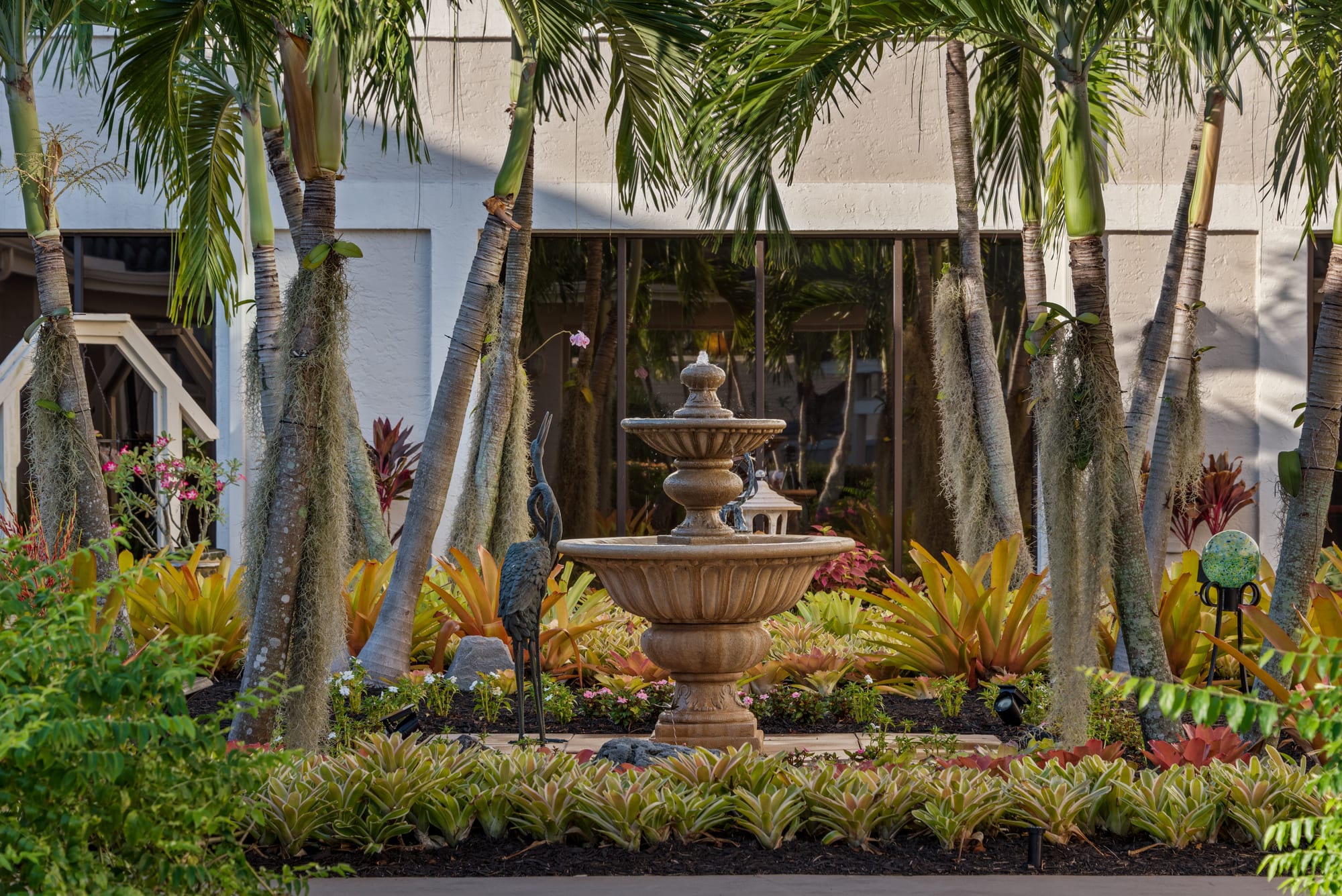 The clubhouse courtyard fountain among palms