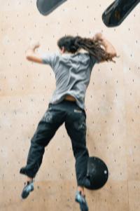 Mauro Schwaszta jumping off a boulder.