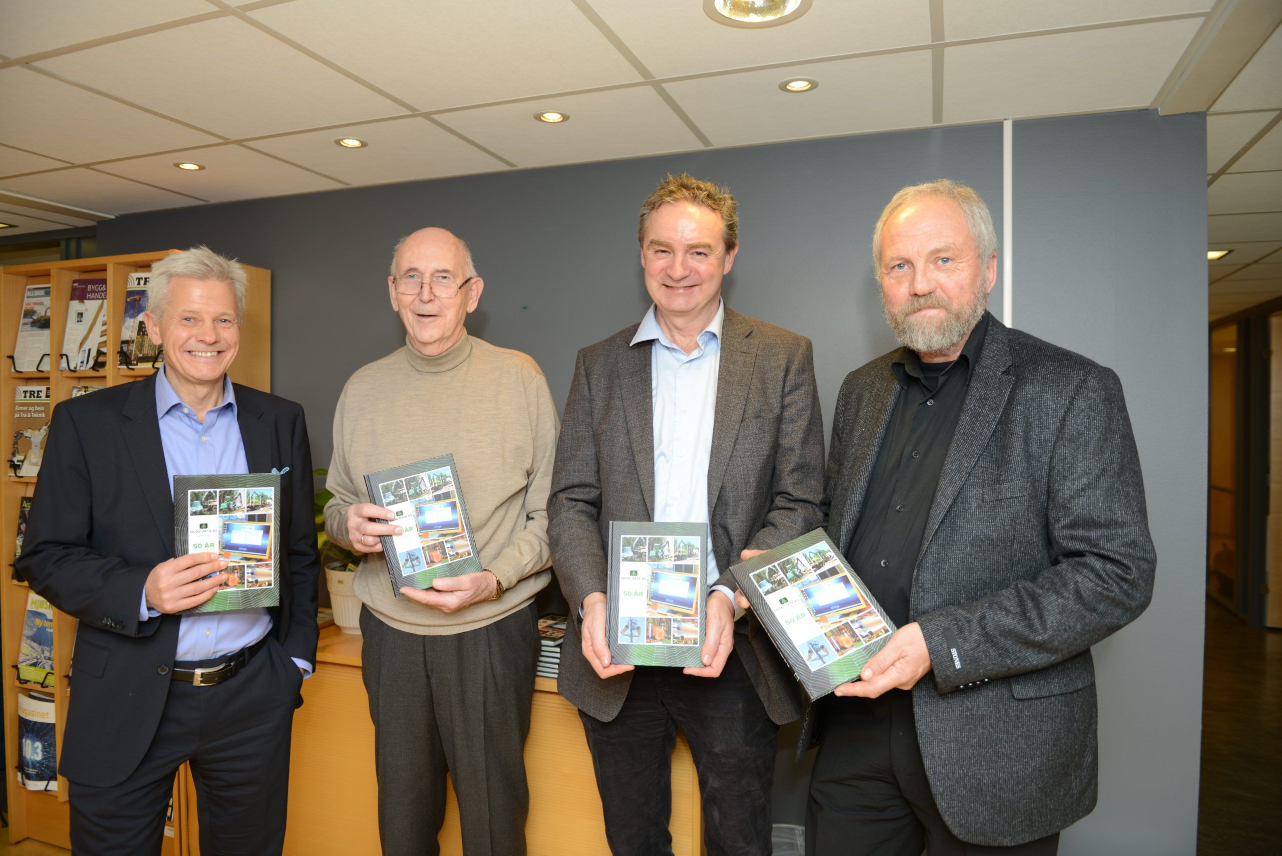 Bildet: Børge Teigland, styreleder; Bertil Akselsen, daglig leder i 30 år (1968-1998); Svend Bøhler, daglig leder og Anders Hals, forfatter av jubileumsboka fra selskapets 50-års-markering den 8. desember 2016.