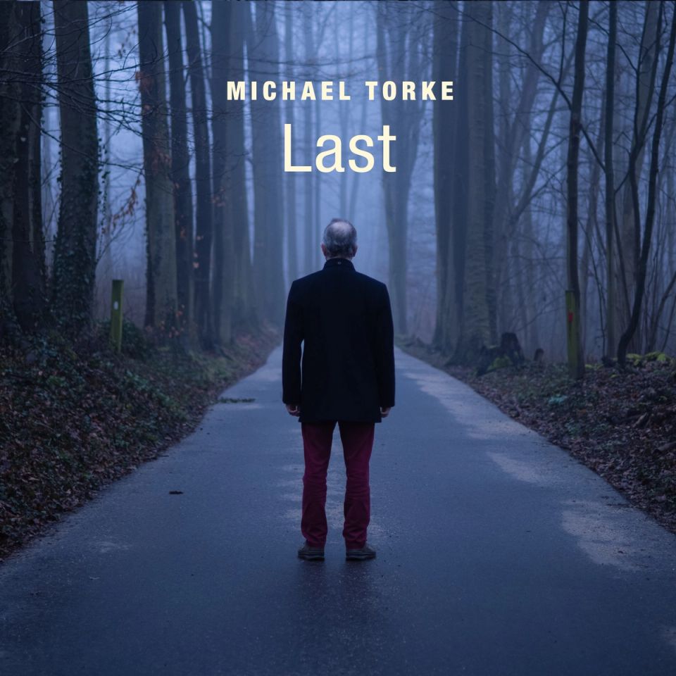 Album cover of Last: a man in a dark coat on a misty forest road
