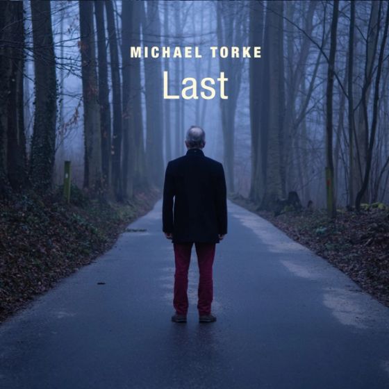 Album cover of Last: a man in a dark coat on a misty forest road