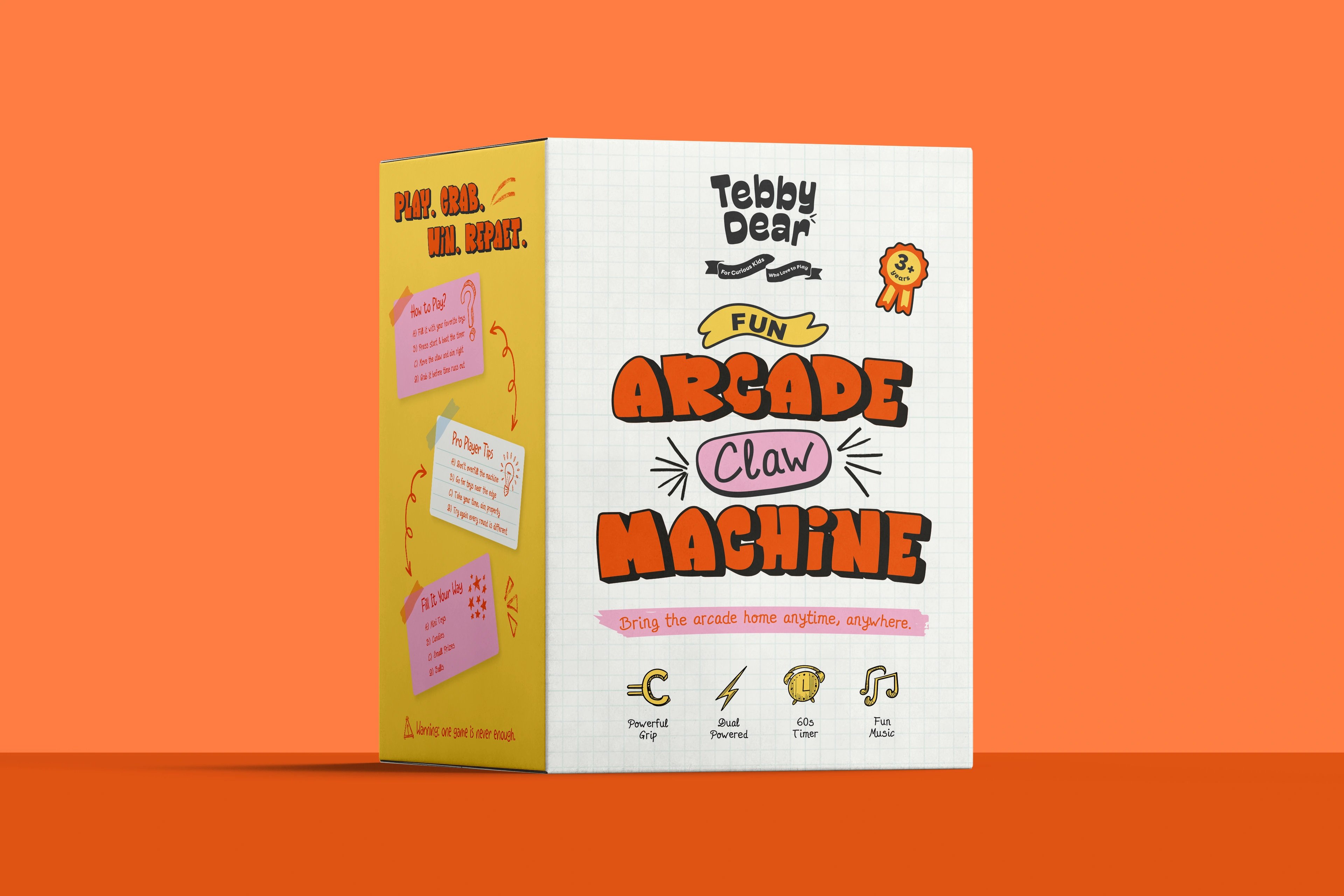 Tebby Dear mini arcade claw machine box standing on a bold orange backdrop
