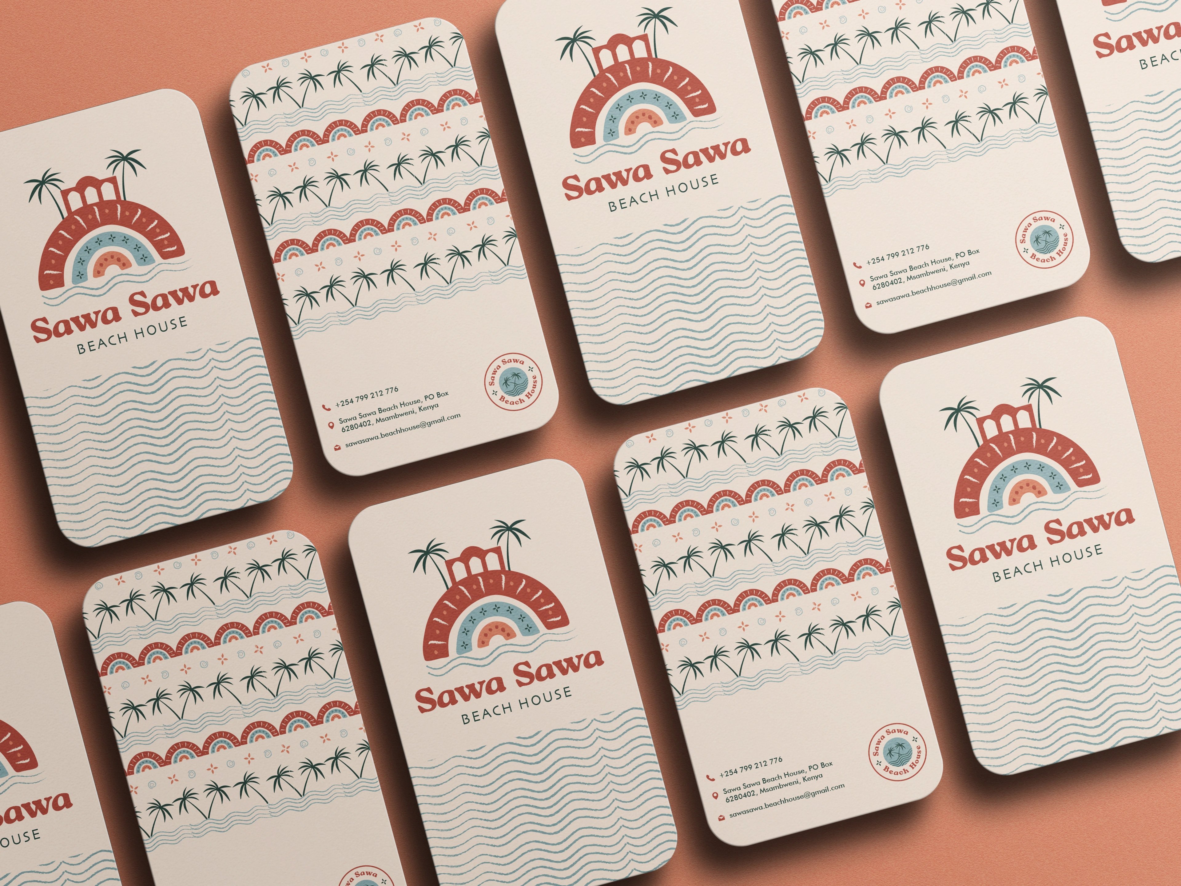 Sawa Sawa Beach House business cards scattered on a cranberry ground, each carrying the arch-and-palm pattern
