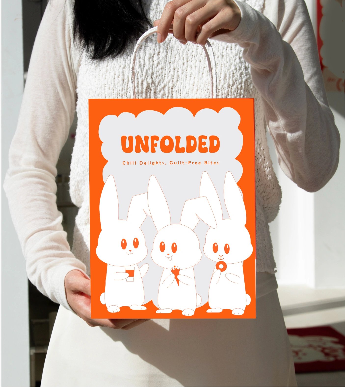 Person holding a knitted UNFOLDED tote bag printed with the bunny poster