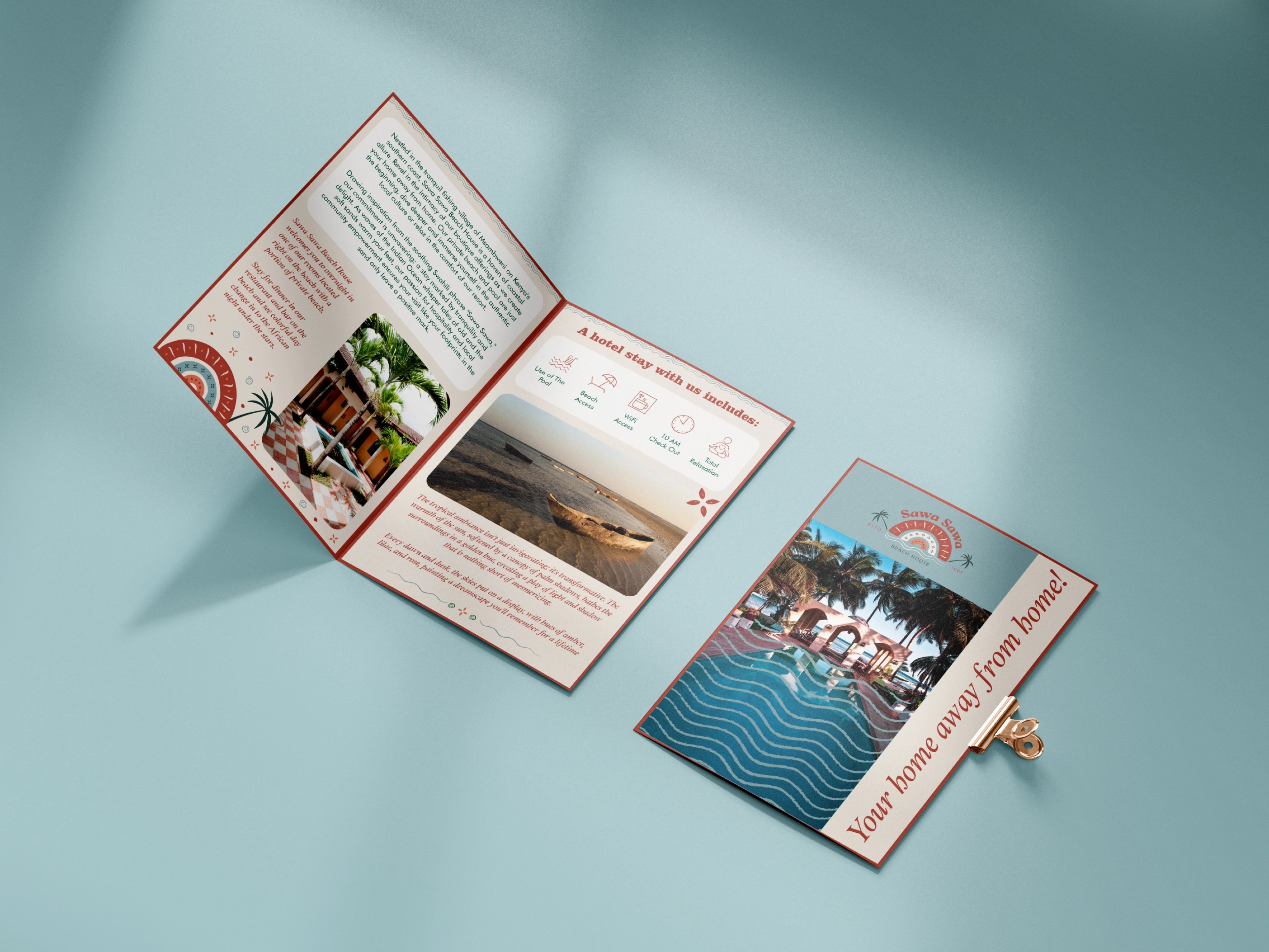 An opened Sawa Sawa Beach House trifold brochure and matching cards photographed on steel blue
