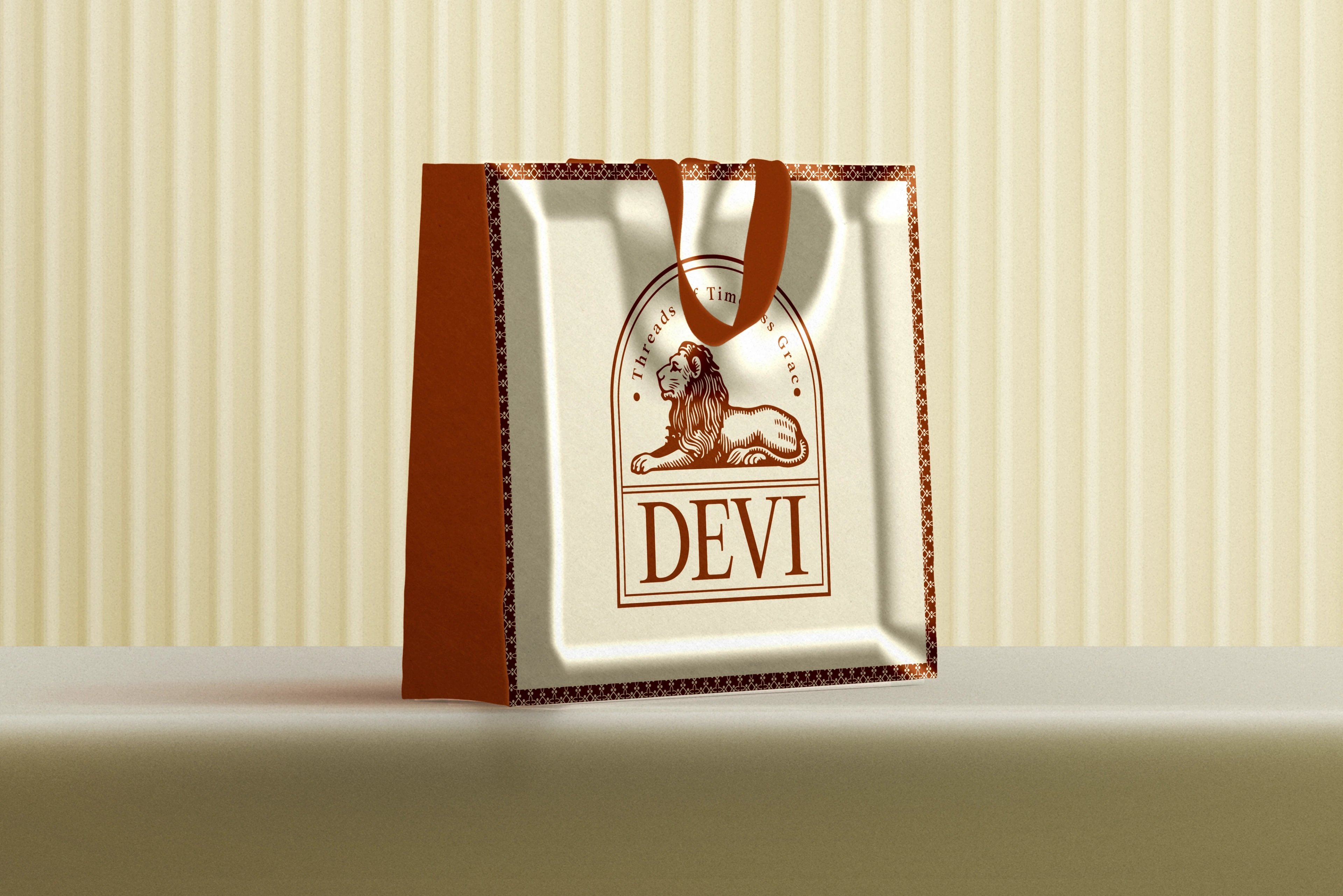 A DEVI shopping bag in rust and cream carrying the lion seal