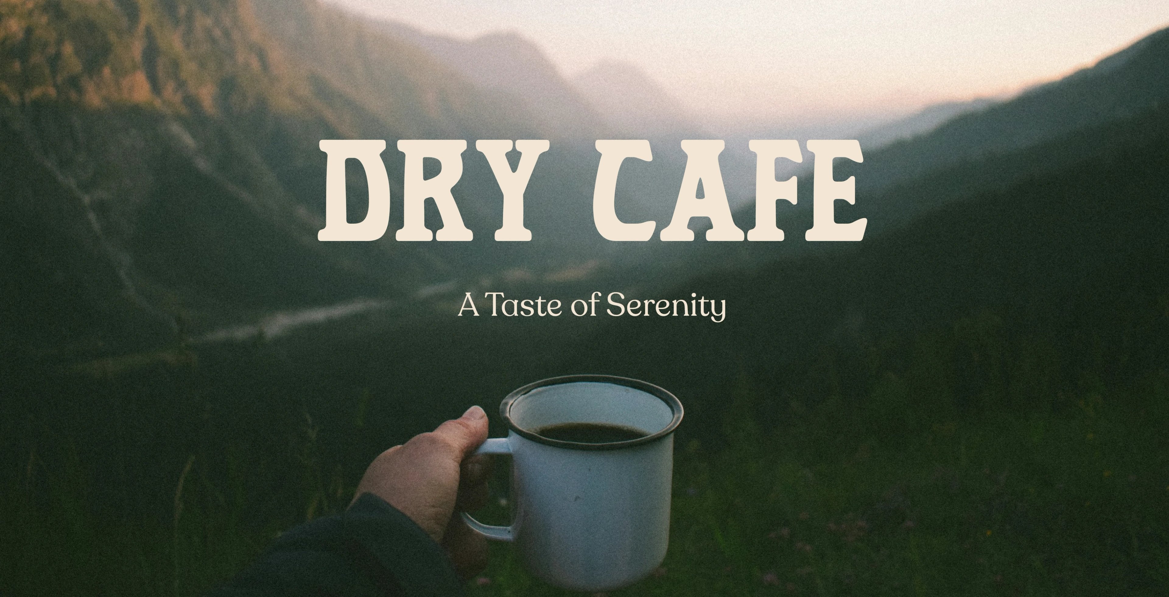 The Dry Café wordmark over a misty Masafi mountain landscape with a hand holding an enamel mug