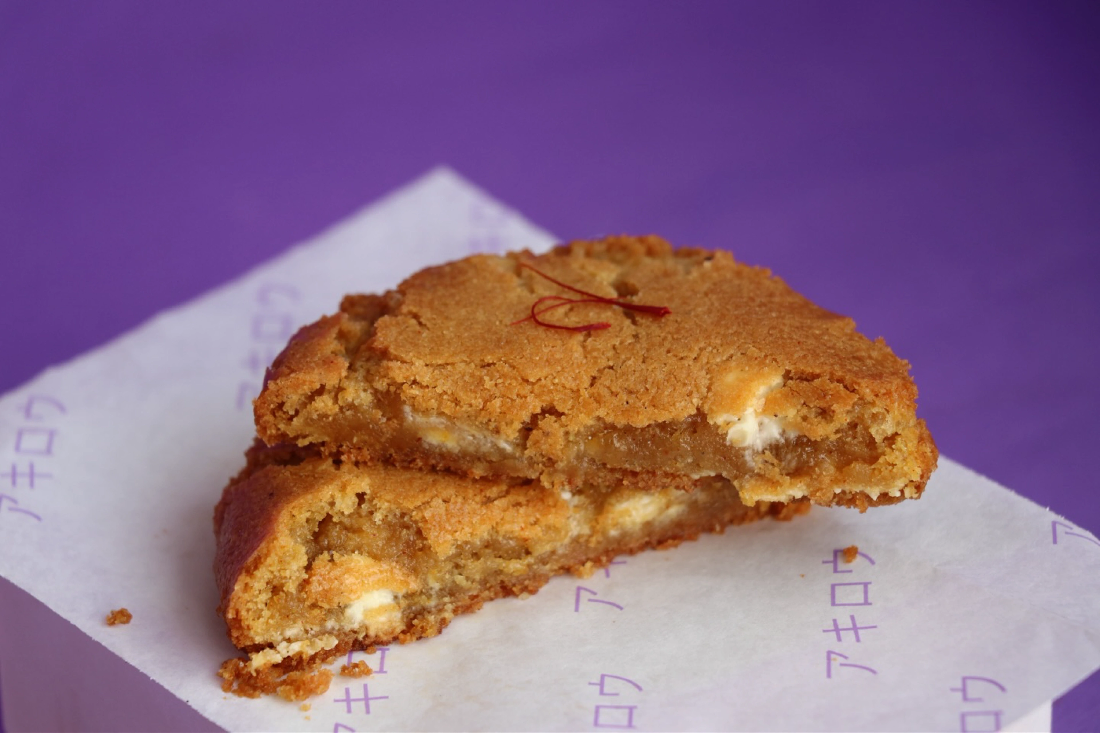 A cracked ÄKIRO cookie broken open to show its molten filling