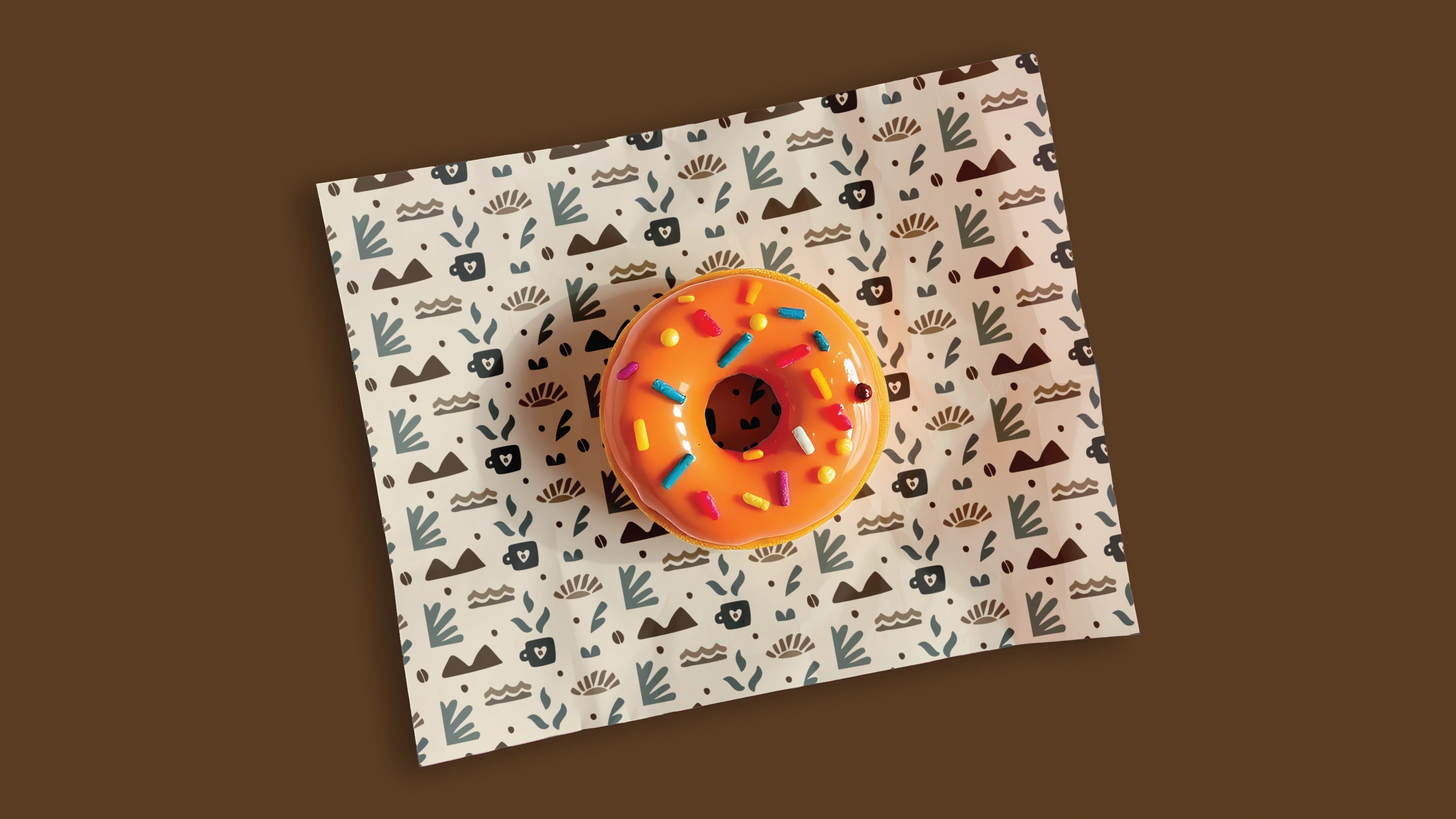 A donut on Dry Café patterned paper against a coffee-brown backdrop