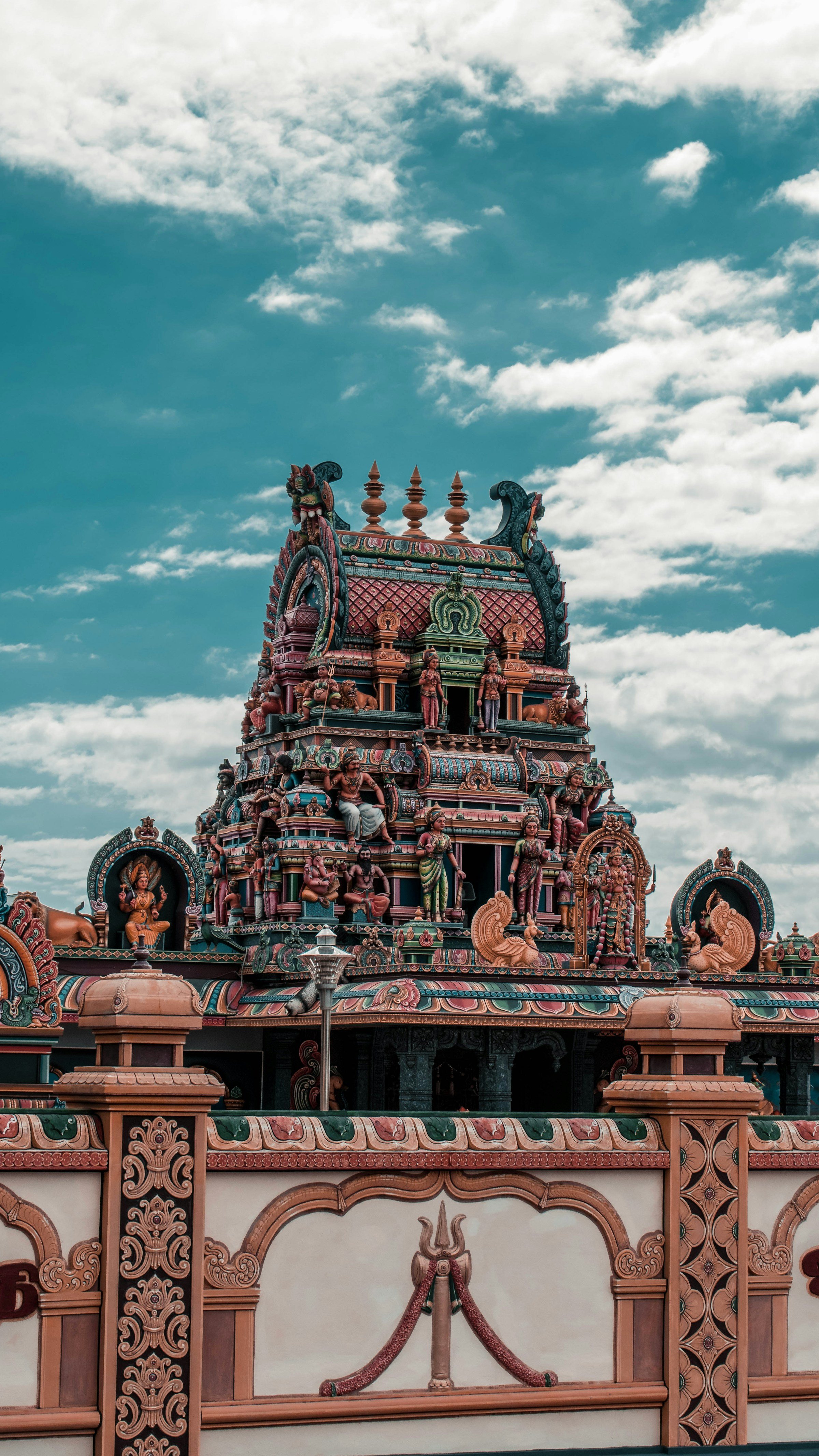 Colourful South Indian temple gopuram against a blue sky