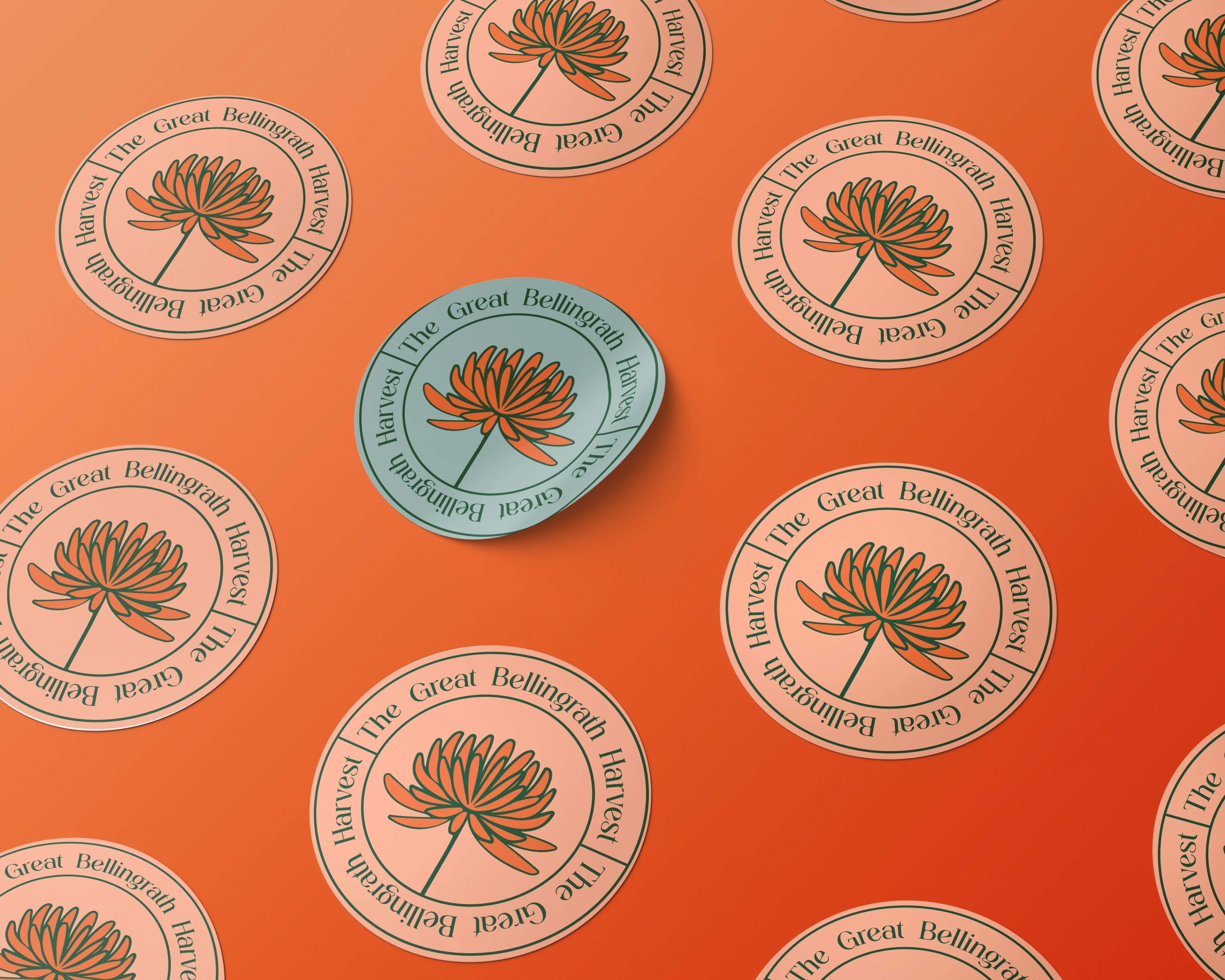 The Great Bellingrath Harvest circular badge stickers tiled across orange harvest packaging, one teal badge lifted from the sheet