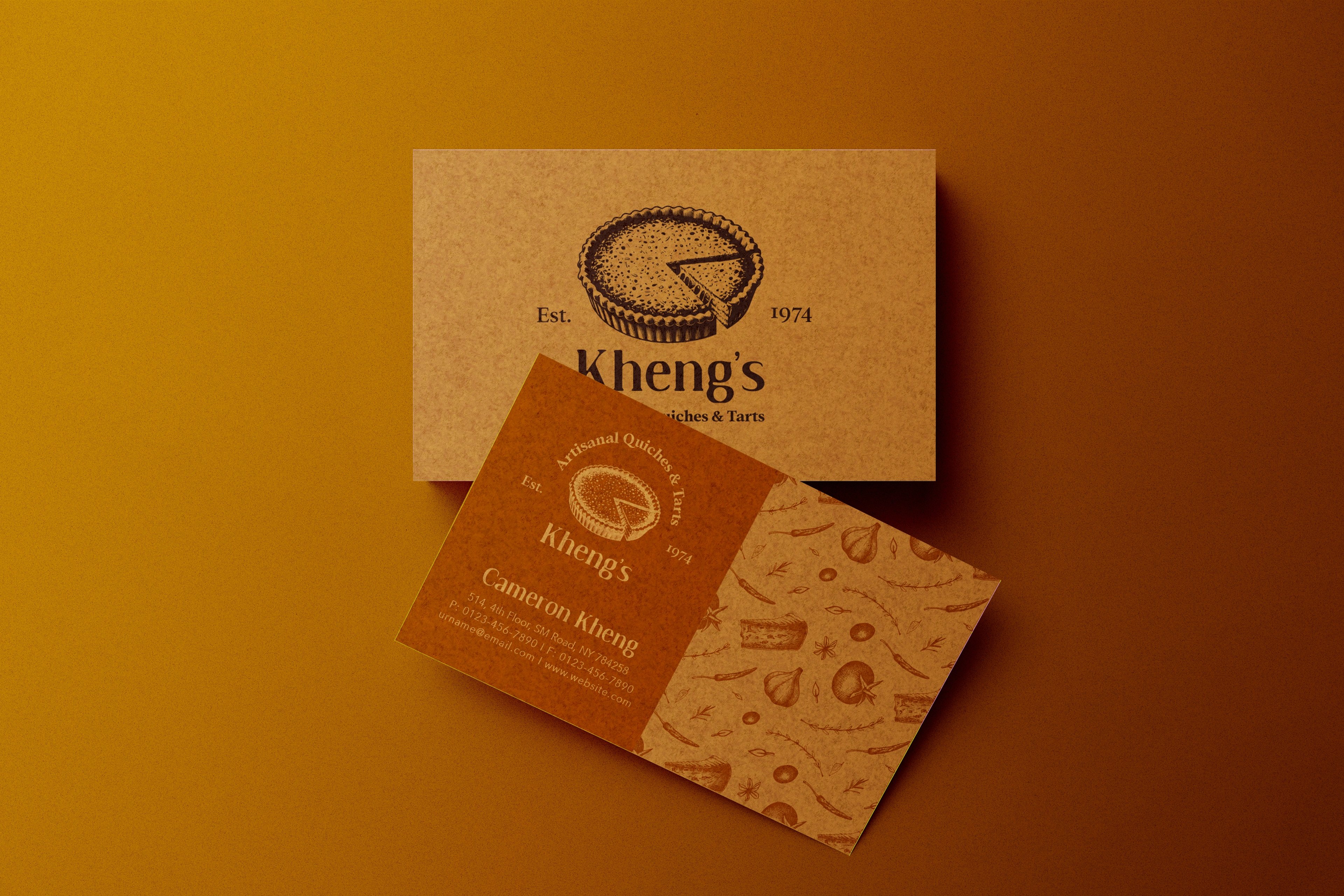 Kheng's kraft business cards with the engraved quiche mark on a warm surface