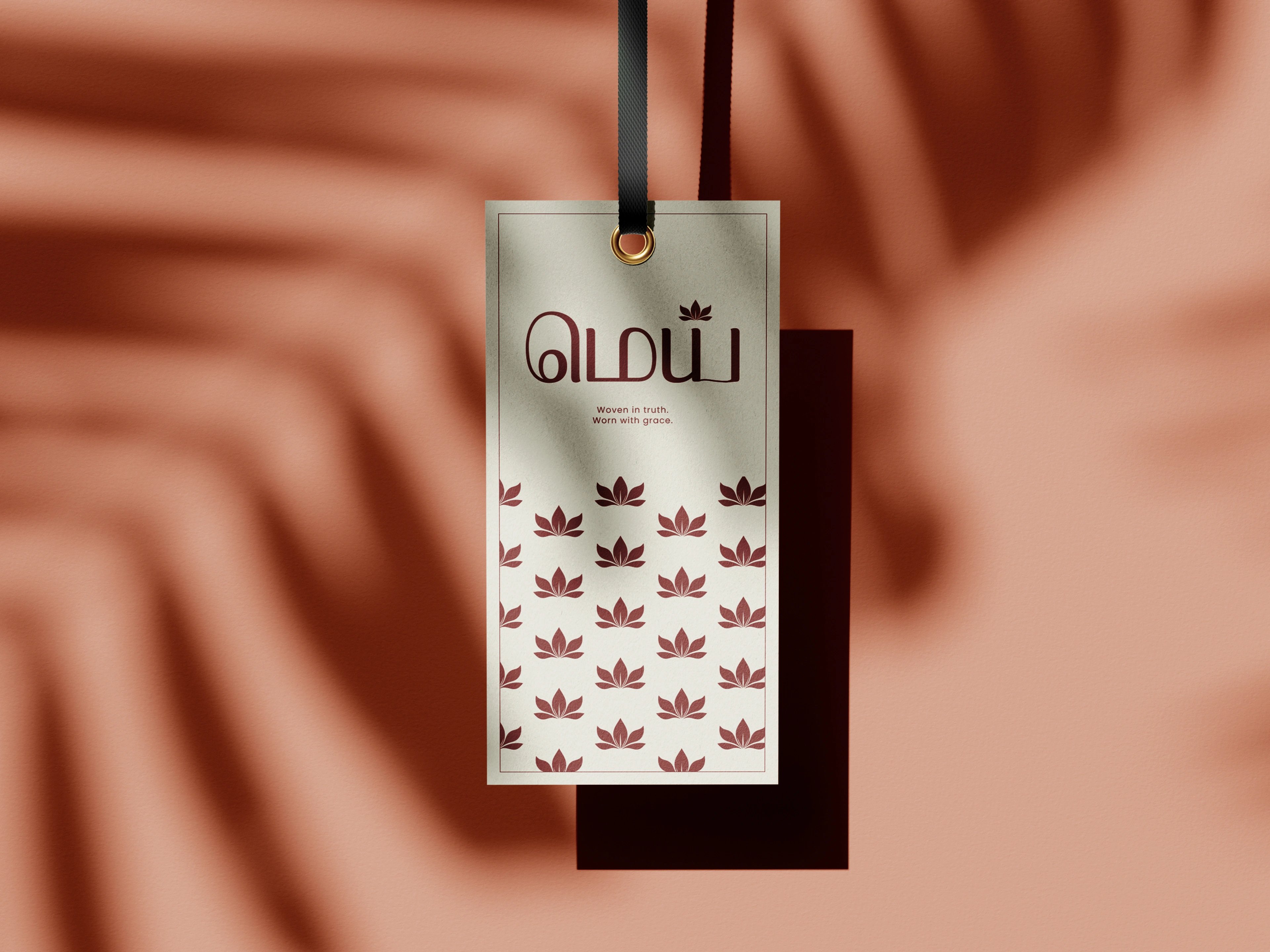 Mei hang tag back in maroon with a repeated lotus pattern