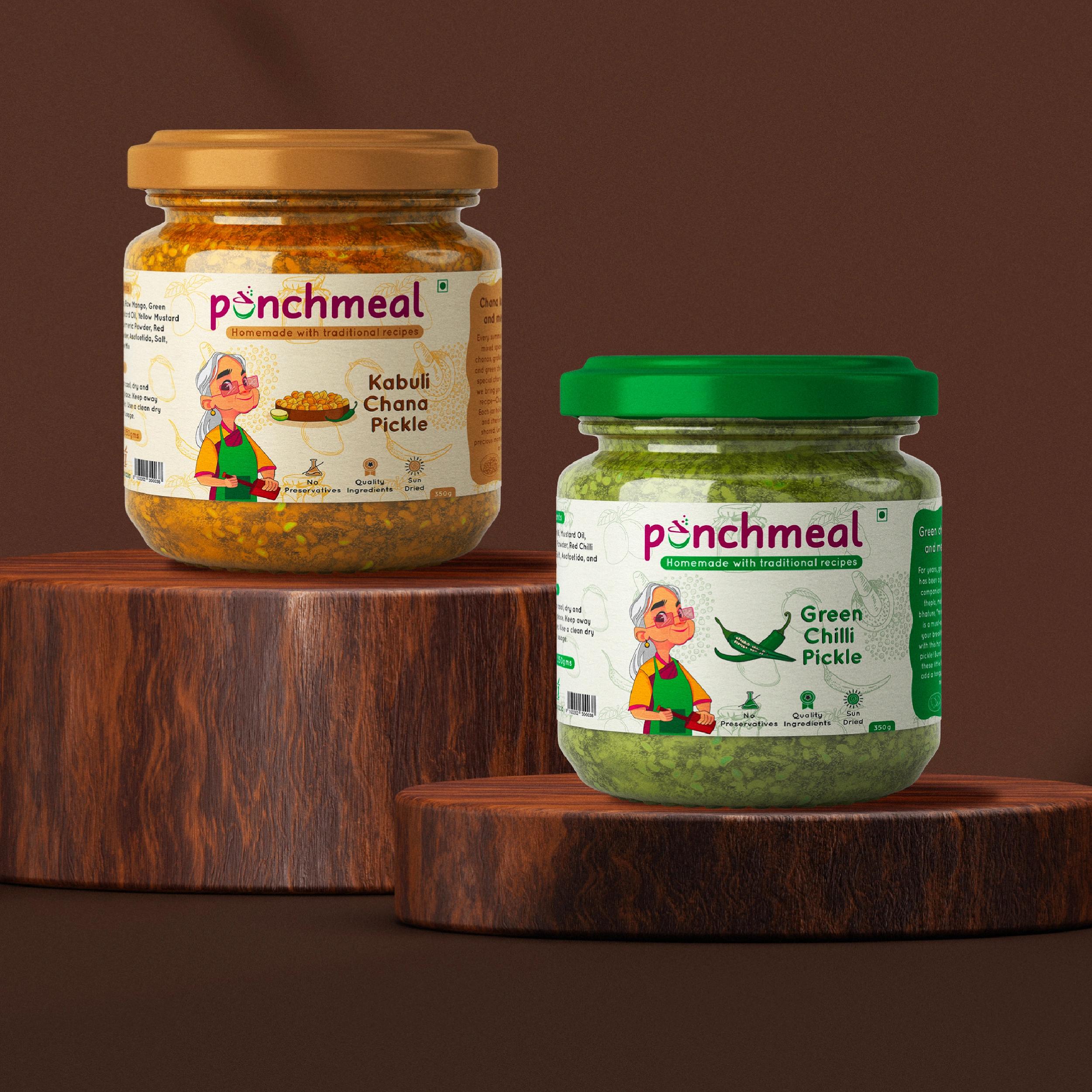 Two Punchmeal pickle jars — Kabuli Chana and Green Chilli — on wooden stands against a dark backdrop
