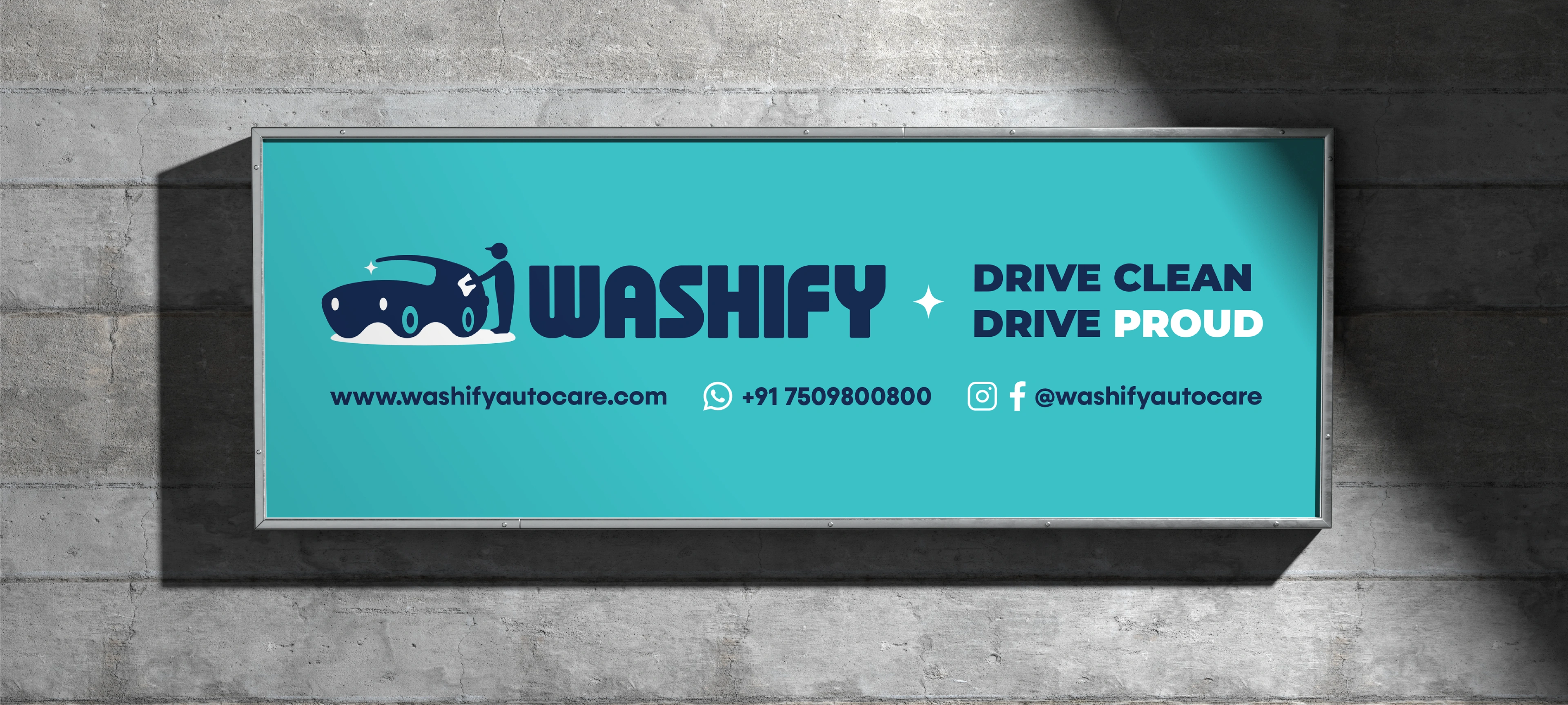 Washify 'Drive Clean Drive Proud' signboard mounted on a concrete wall