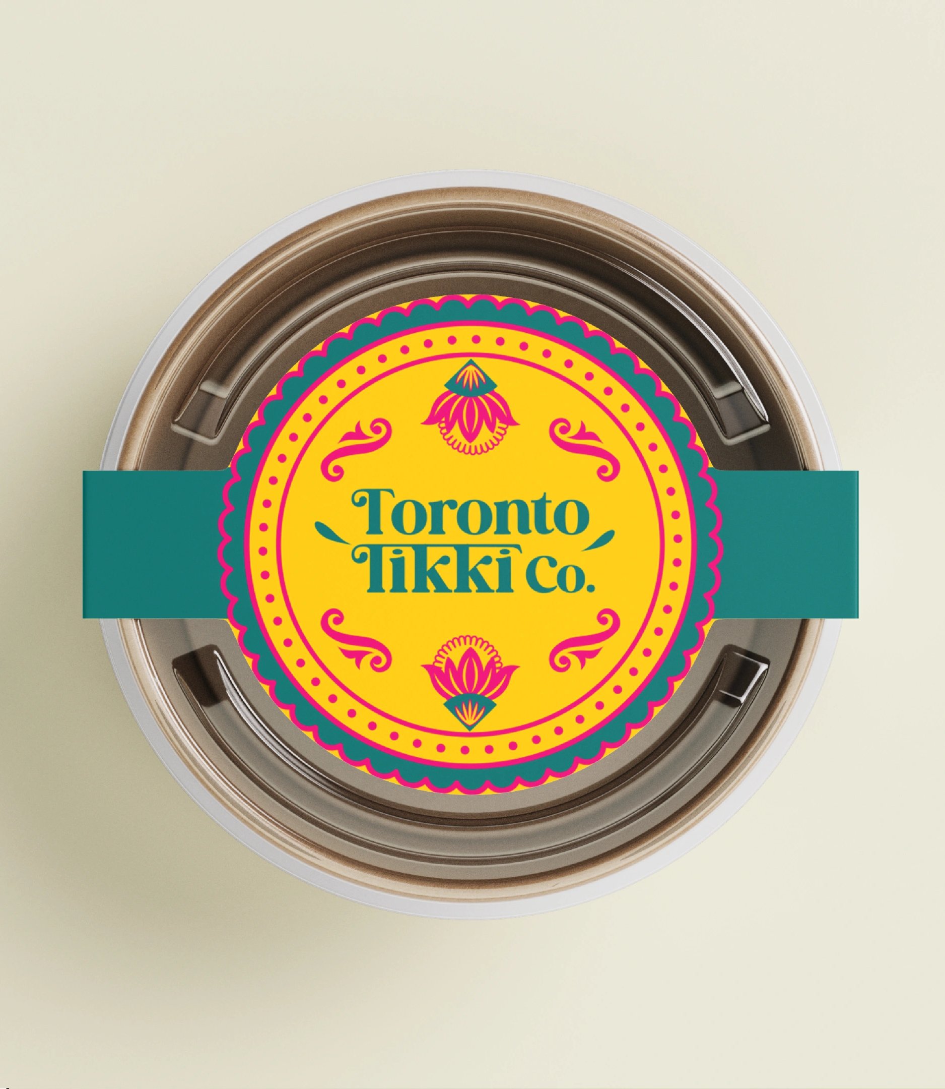 The Toronto Tikki Co. wordmark embossed on cream packaging beside a tin sealed with a teal belly band