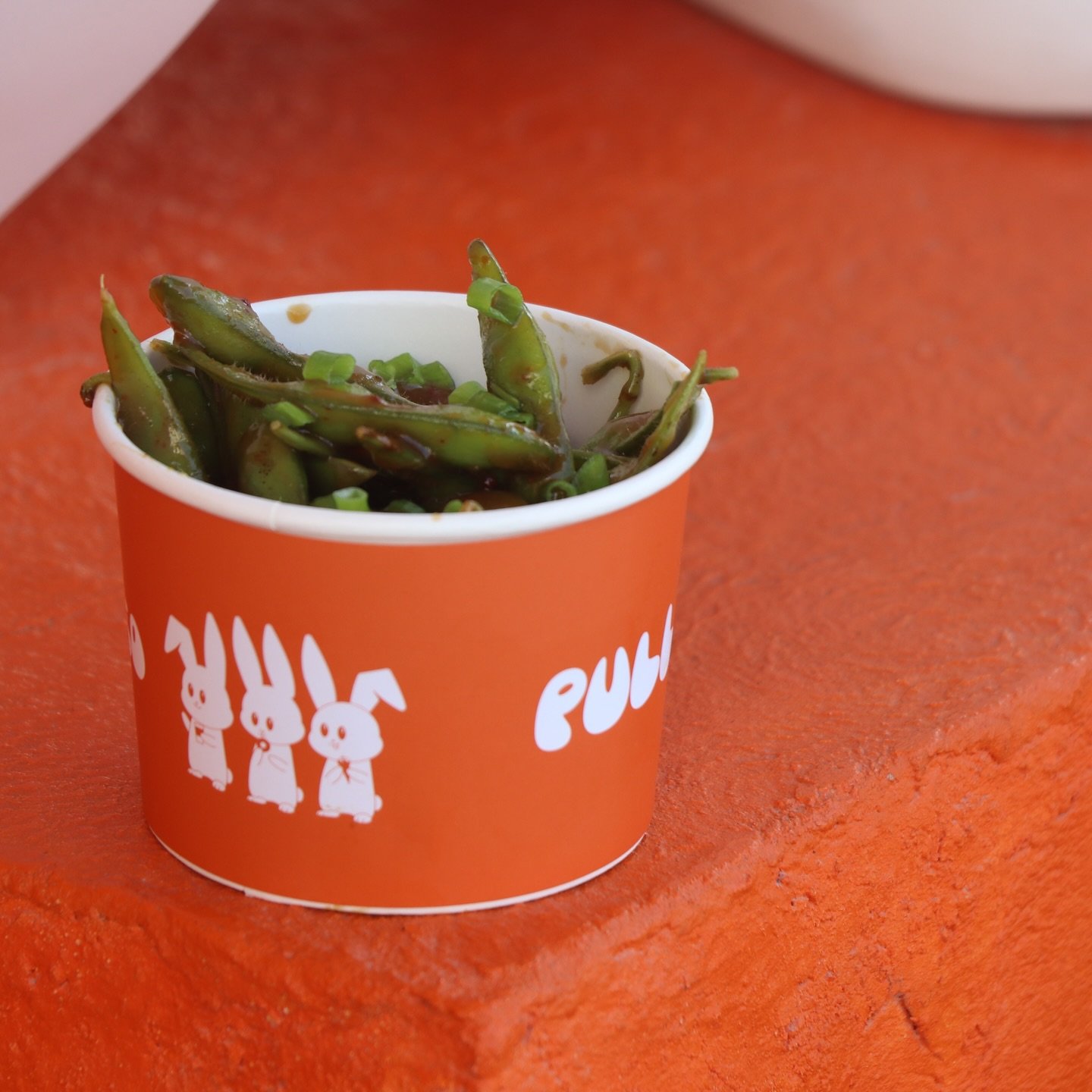 PULL chilli-garlic edamame served in the orange bunny-print cup