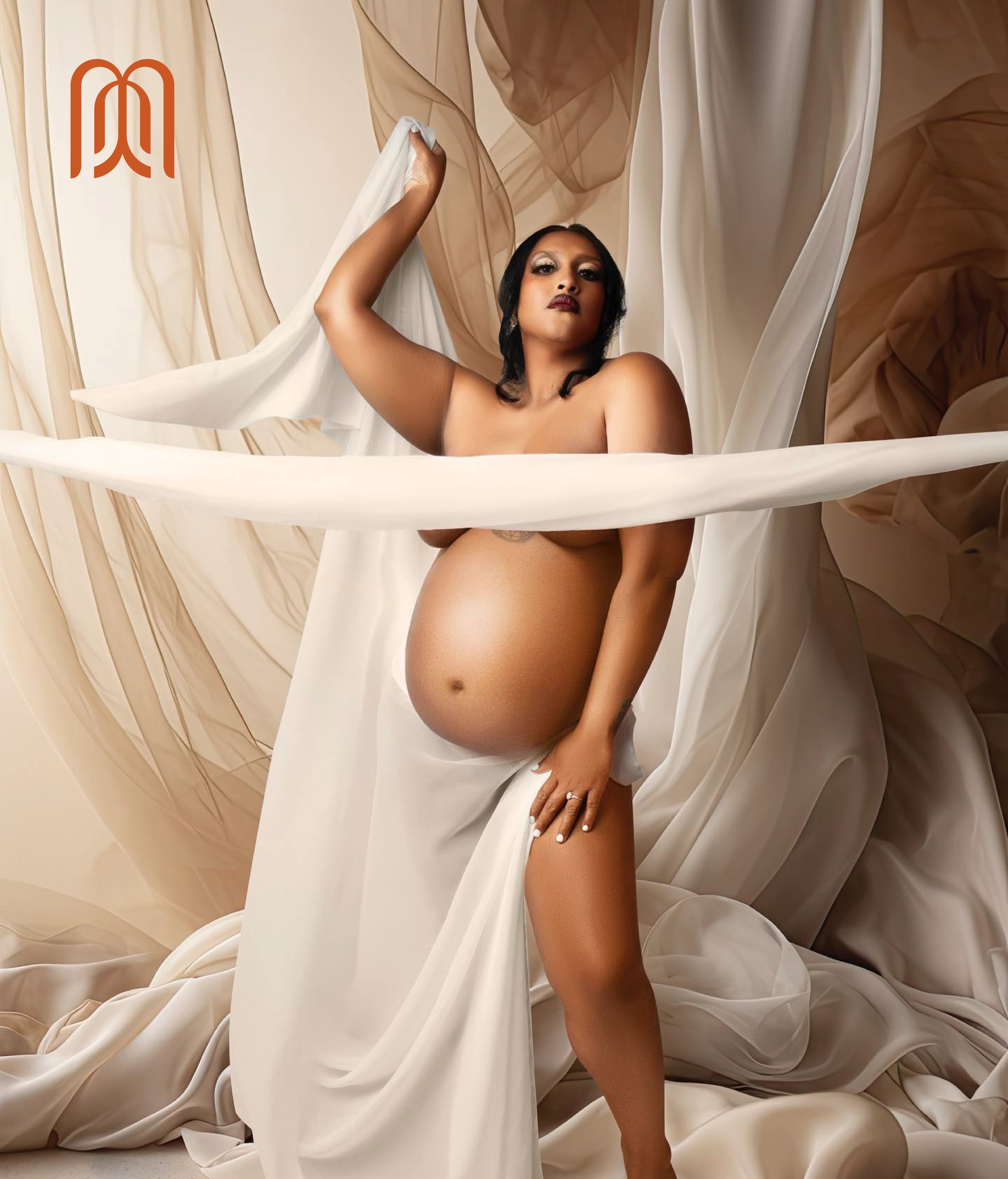 a maternity portrait of an expectant mother standing in sheer draped fabric, one arm raised