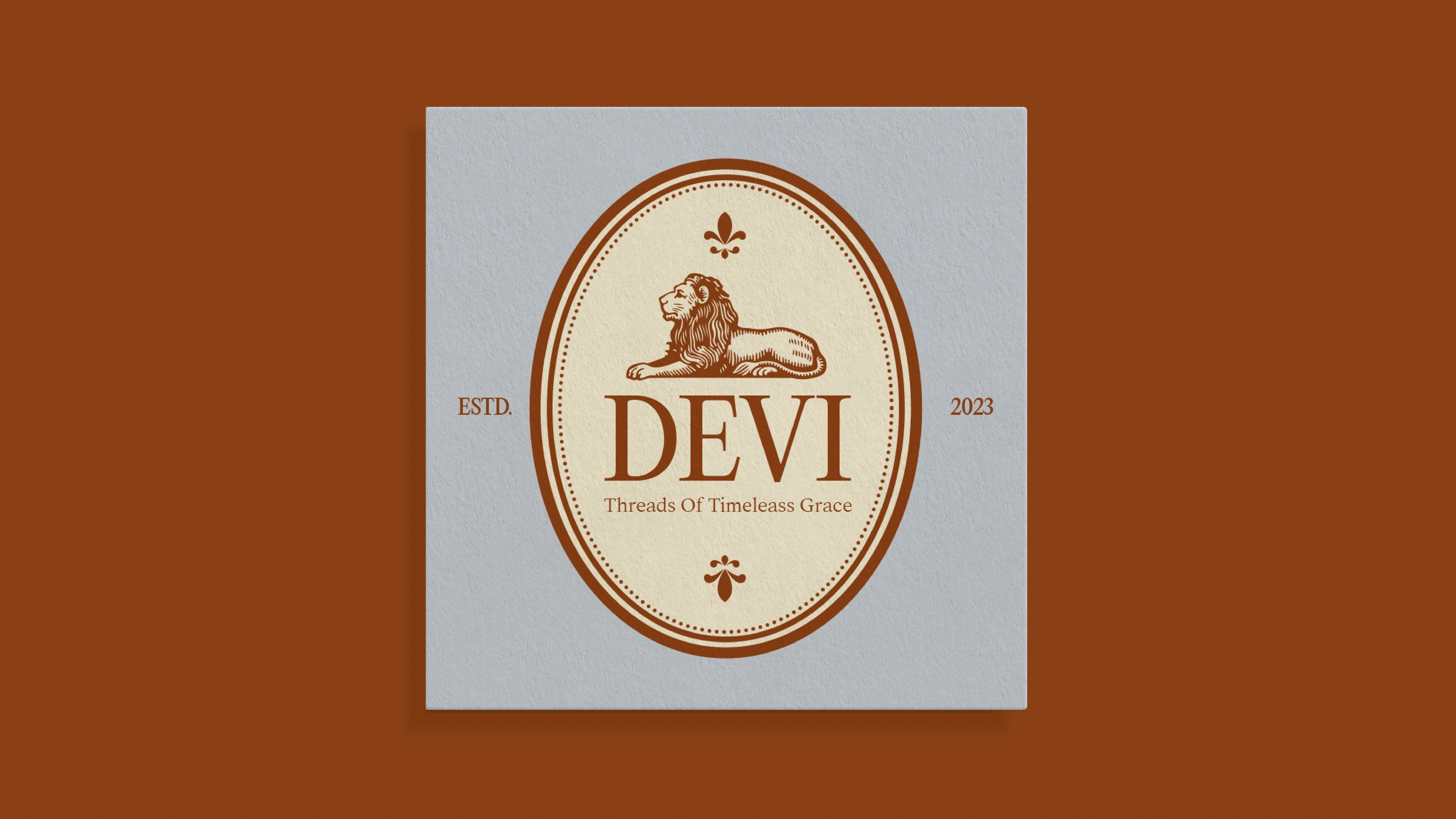 The DEVI lion seal in a cream square on a deep rust background
