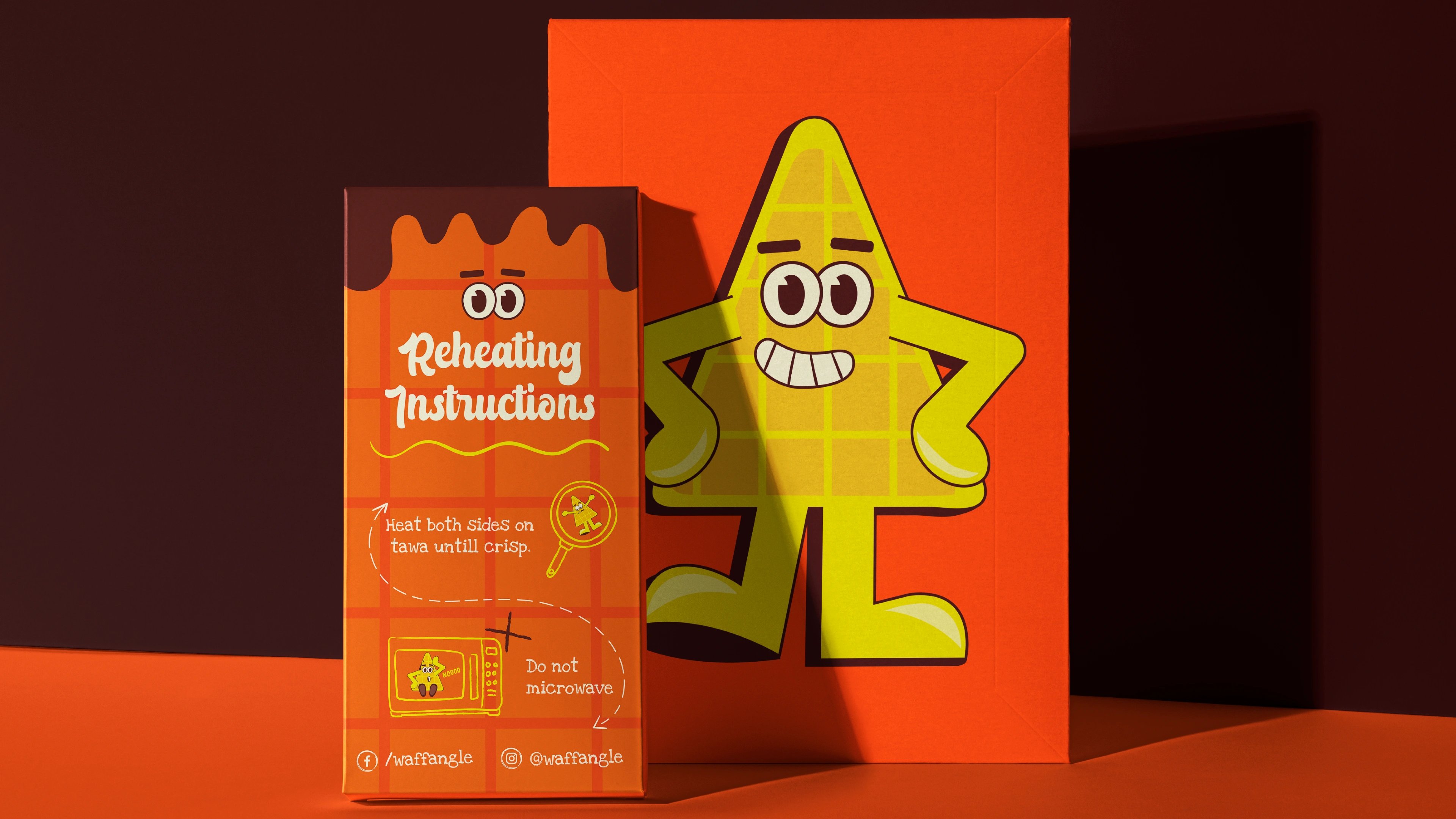 Waffangle reheating-instructions carton beside a standing waffle-mascot cutout on orange