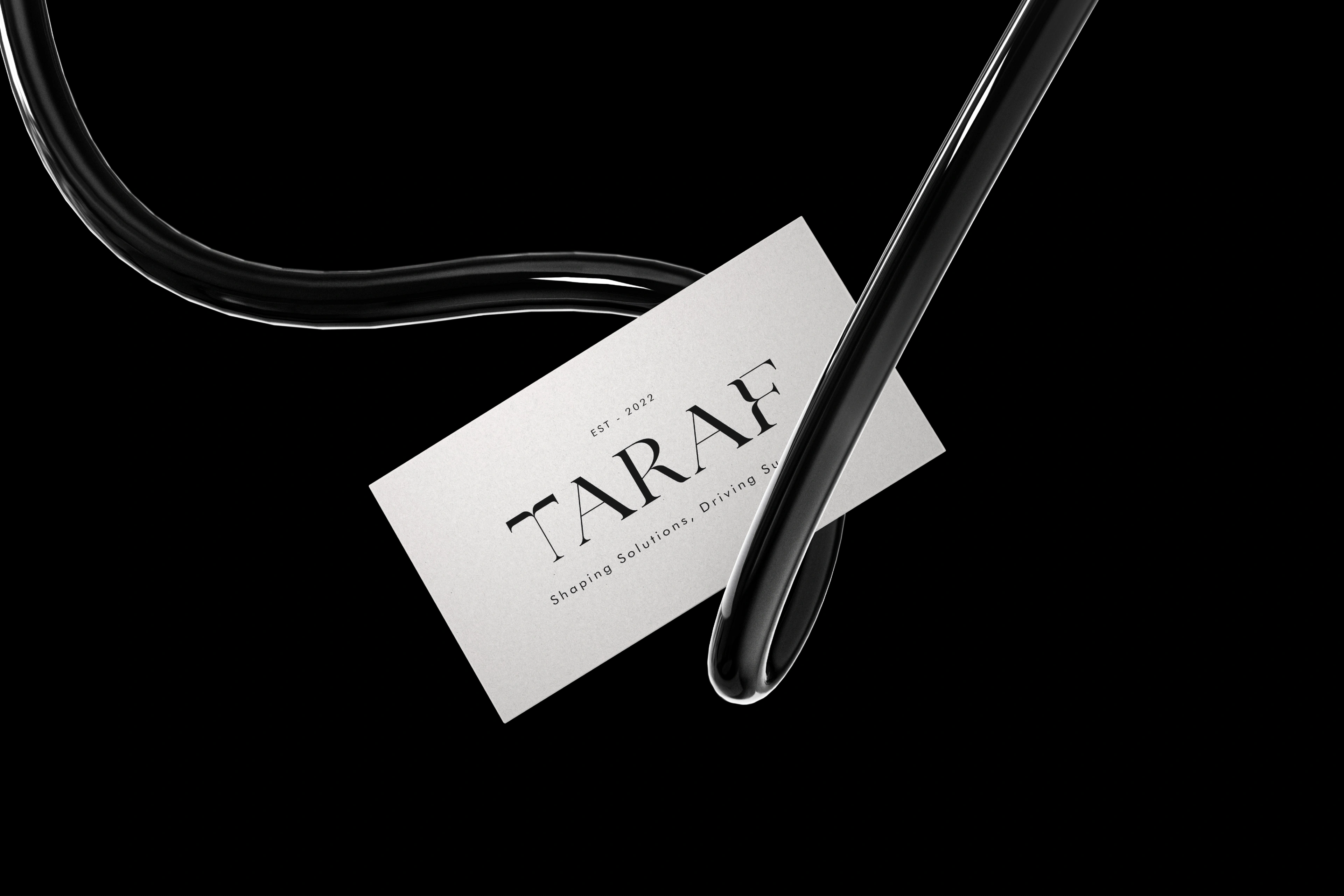 Taraf letterpress business card with a curved wire on a black surface