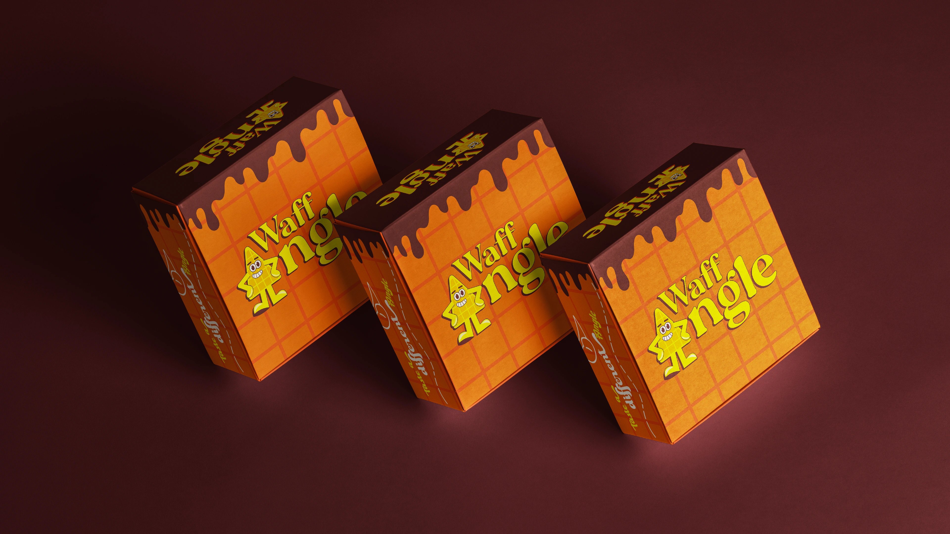 Three Waffangle chocolate-drip takeaway boxes arranged on a brown surface