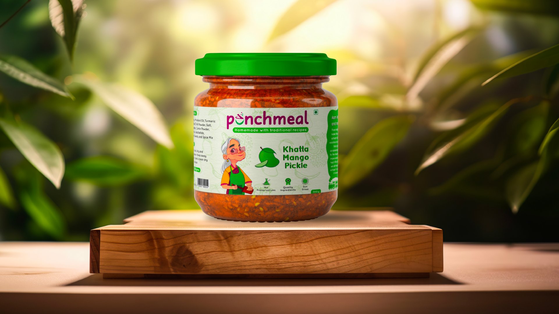 Punchmeal Khatta Mango Pickle jar on a wooden block against sunlit green foliage