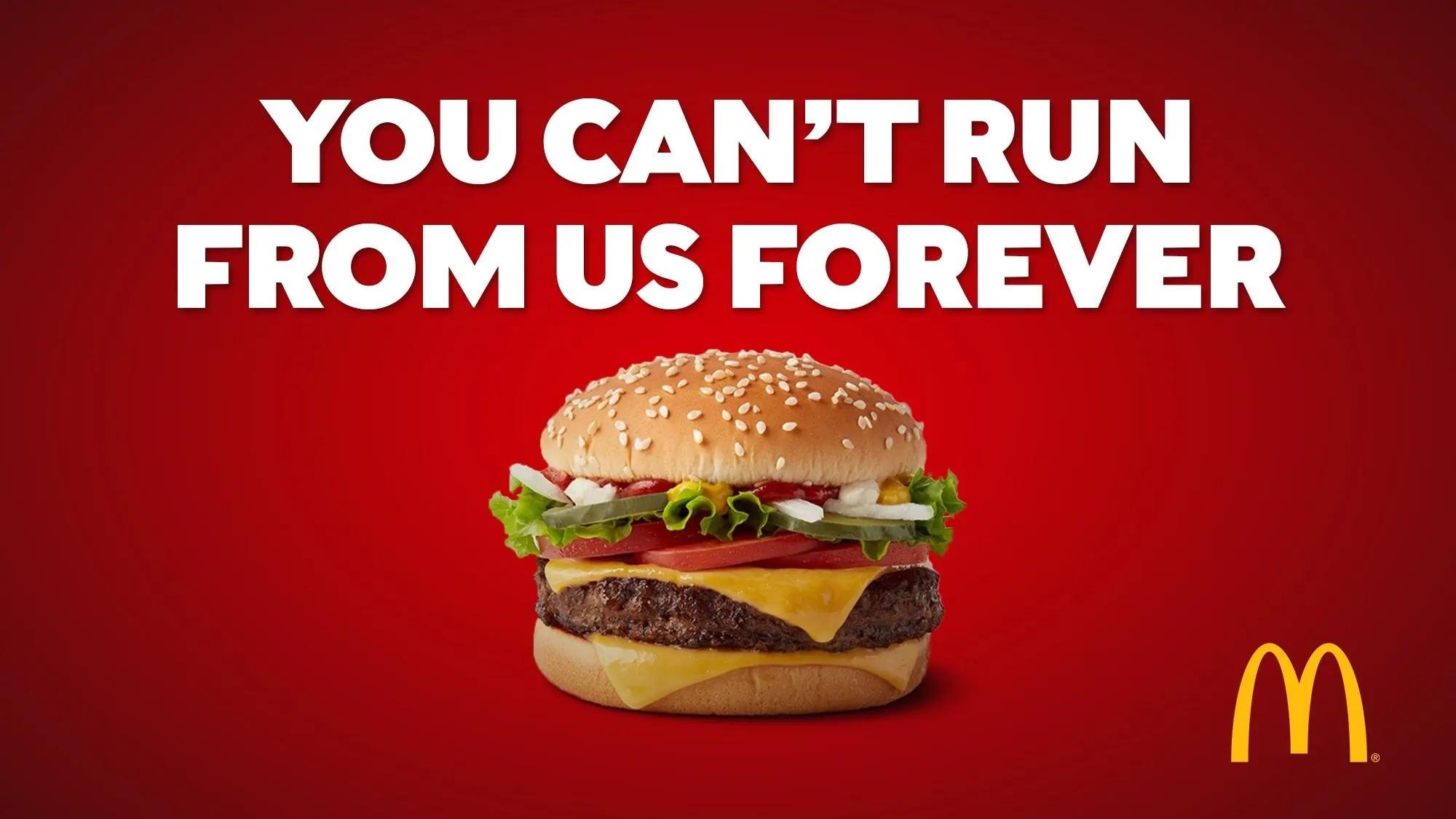 A McDonald’s ad on a red background reading “you can’t run from us forever” above a cheeseburger and the golden arches