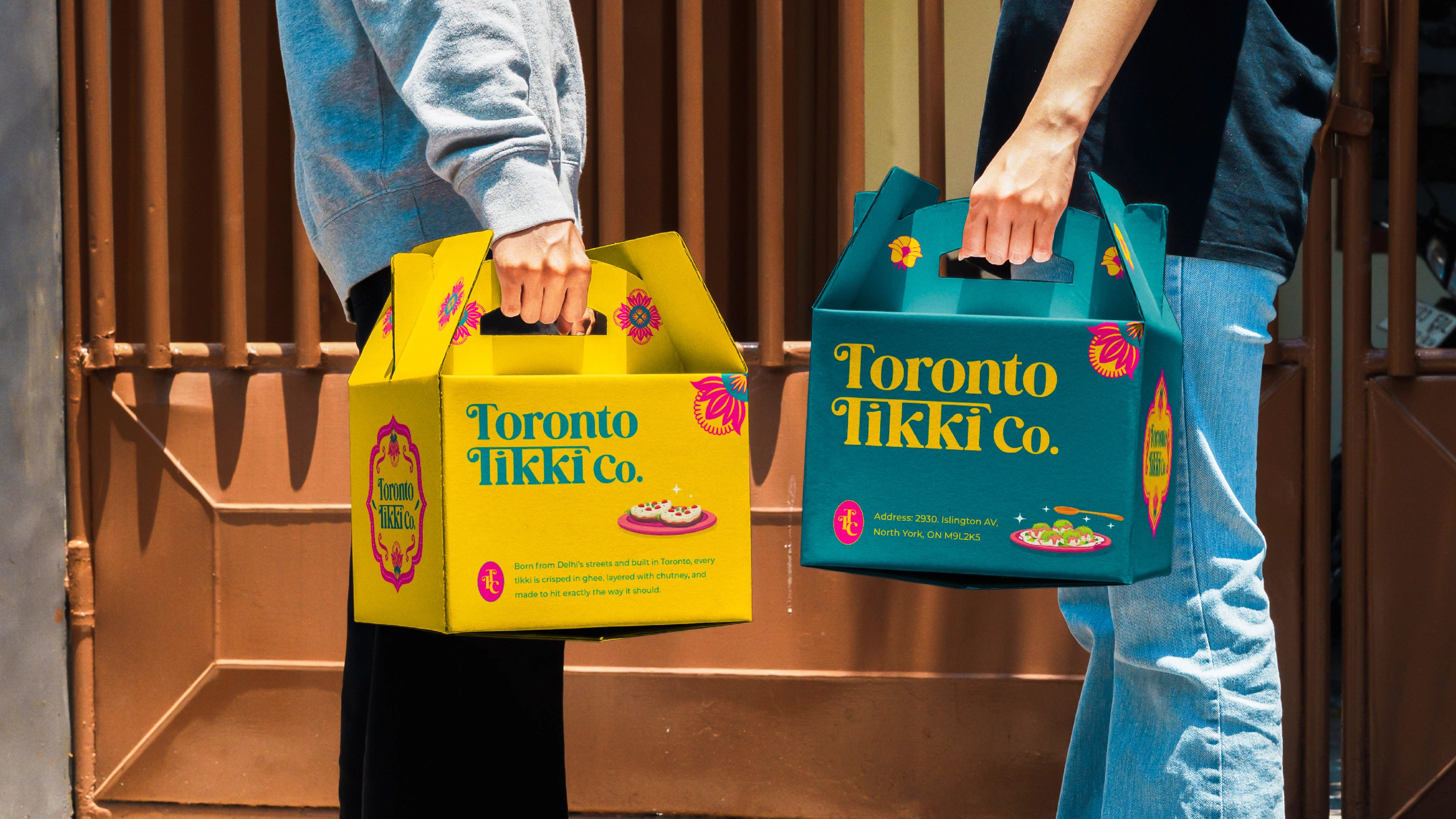 Two people carrying yellow and teal Toronto Tikki Co. takeaway boxes down a staircase