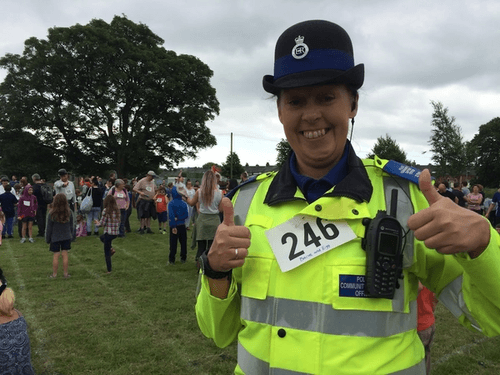 Police woman with thumbs up