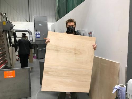 man holding board in warehouse