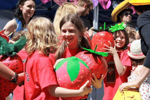 Children holding strawberries