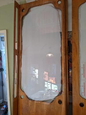Wooden frame with plastic covering window holes