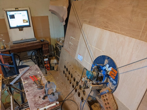 Computer, workbench and hanging cnc machine in a shed