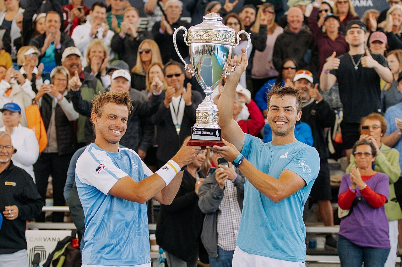 Ben Johns (right) and his brother Collin Johns holding the men's doubles trophy at the PPA Arizona Grand Slam in February 2023