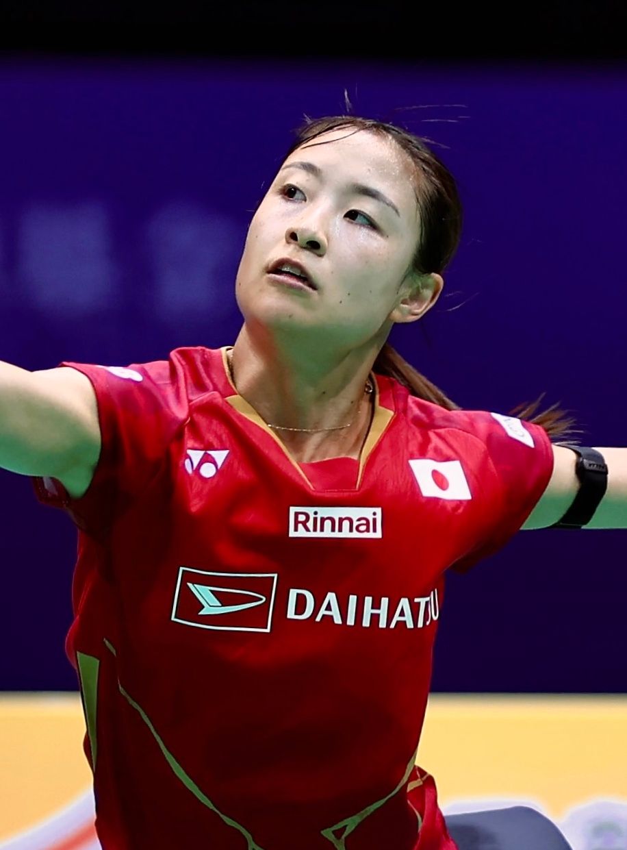 Nozomi Okuhara playing badminton in a Japan shirt
