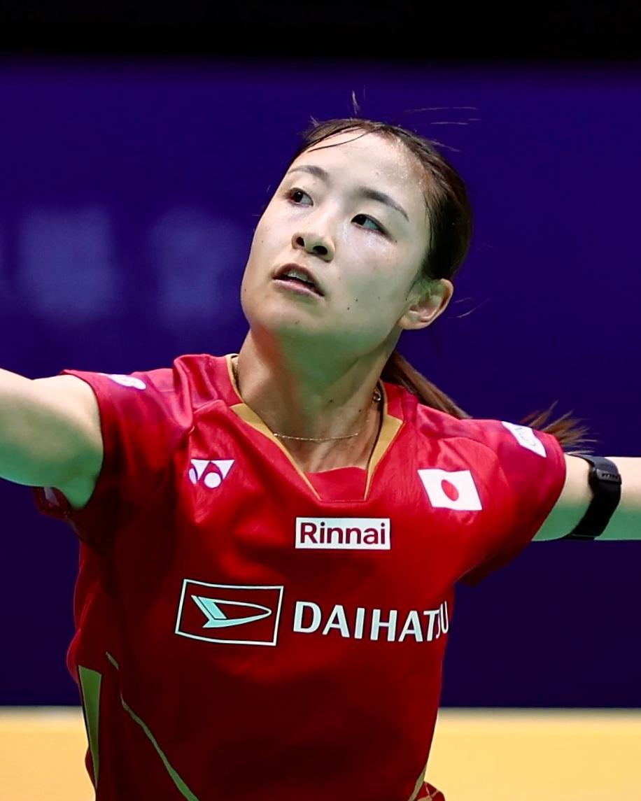 Nozomi Okuhara playing badminton in a Japan shirt