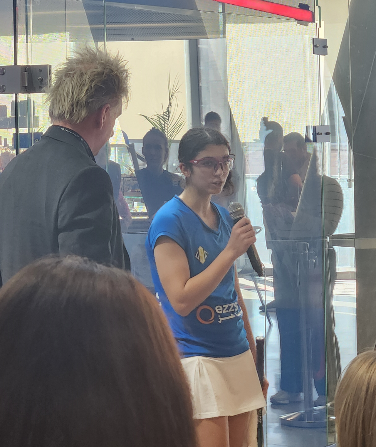 Amina Orfi speaking after a squash match in Washington DC, February 2024